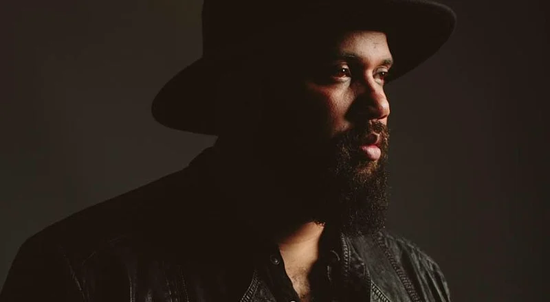 Stylish portrait of a man in a leather jacket and hat