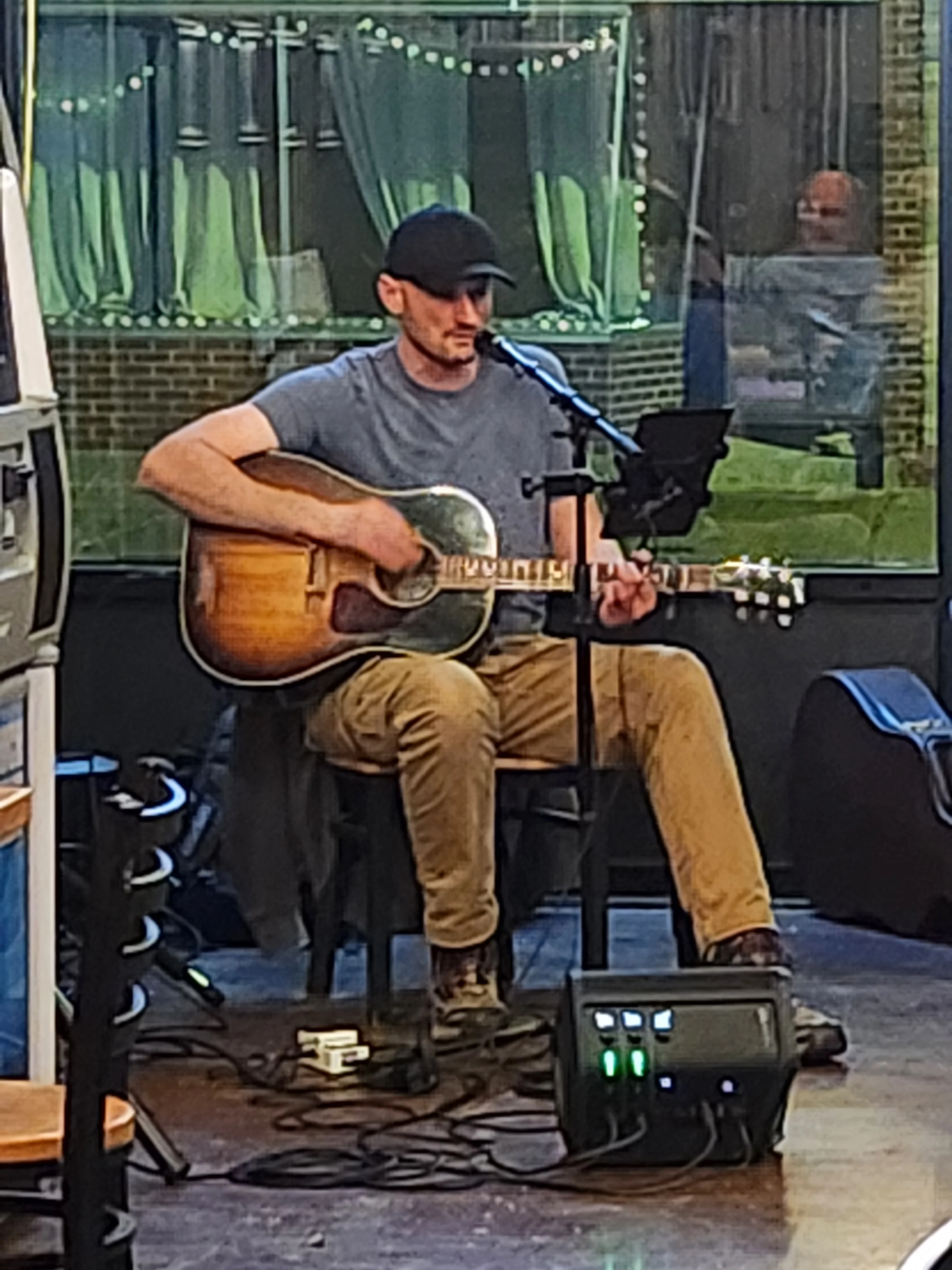 Live musician performing with guitar in a cozy restaurant setting