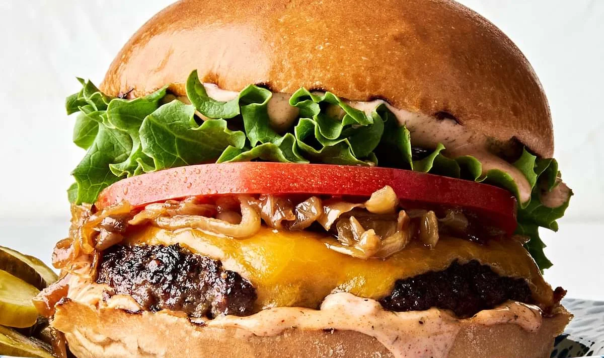 Classic cheeseburger with lettuce, tomato, and cheese on a toasted bun