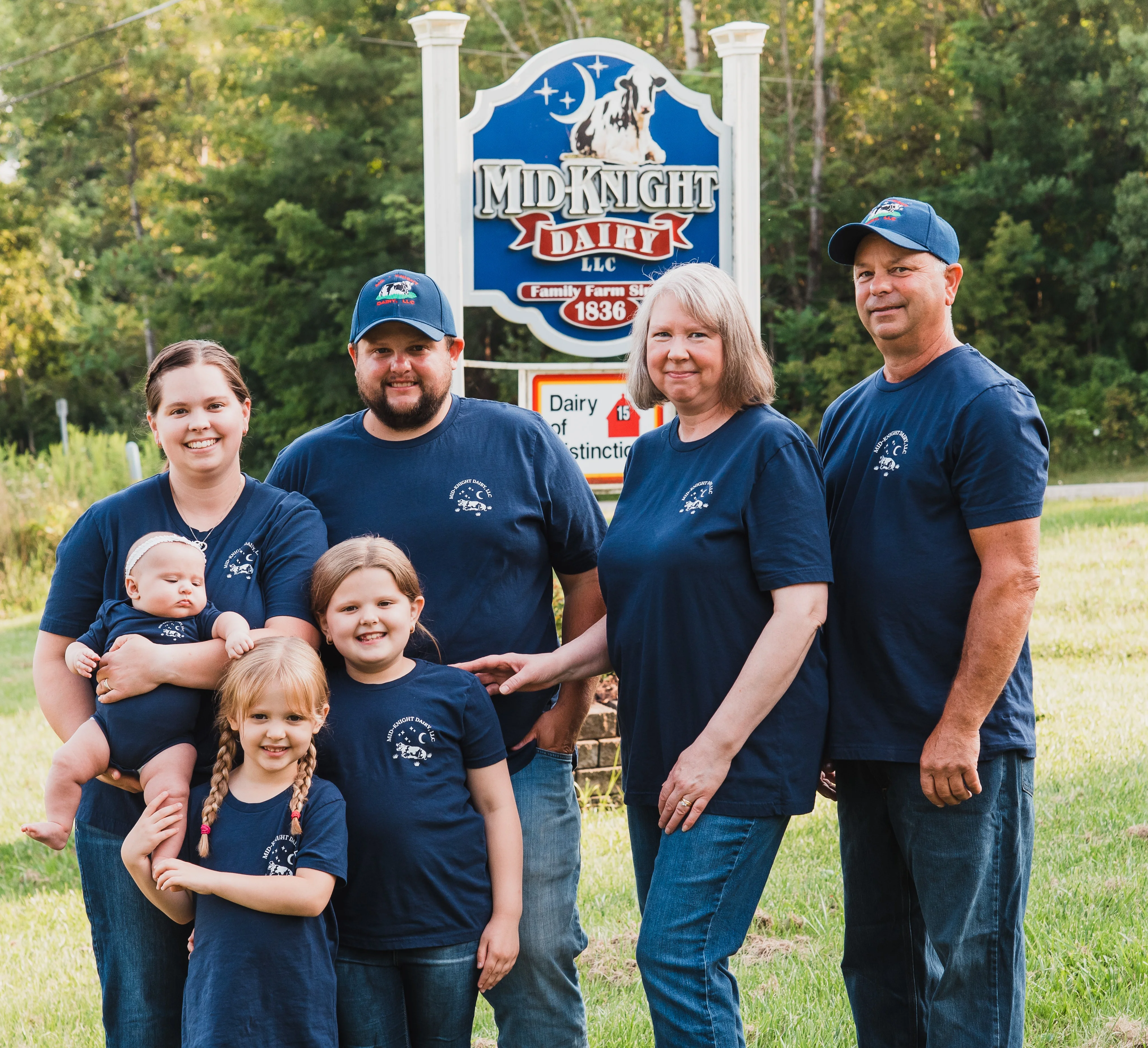 Family portrait in front of Midnight Dairy sign