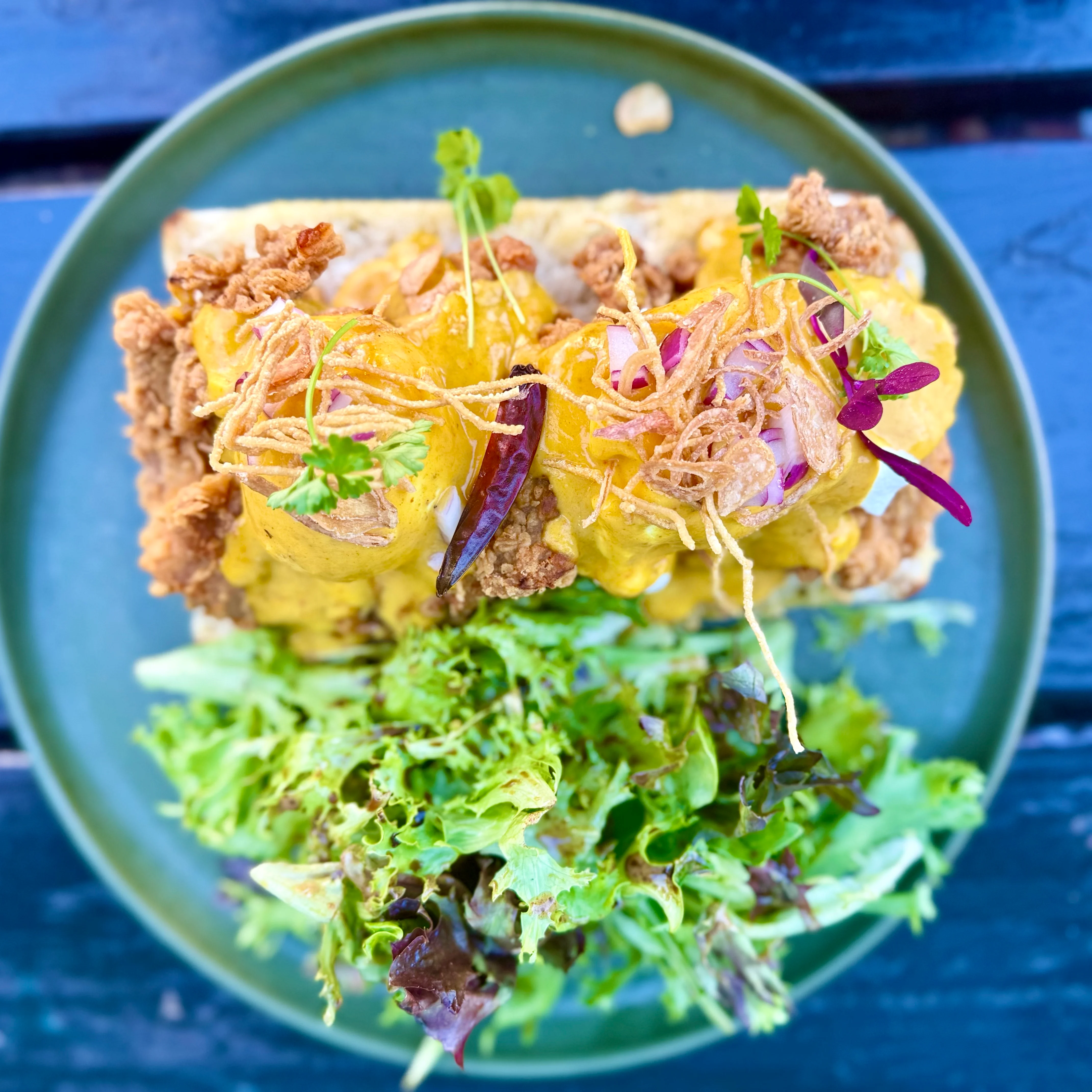 Crispy fried chicken sandwich with salad