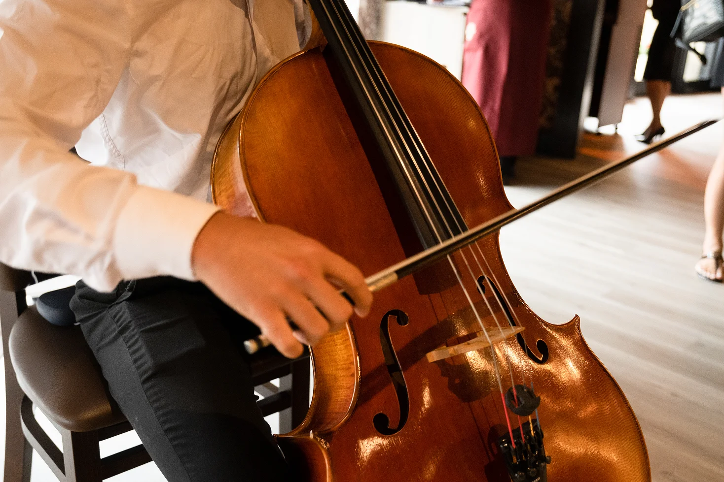 Cellist performing in a restaurant setting