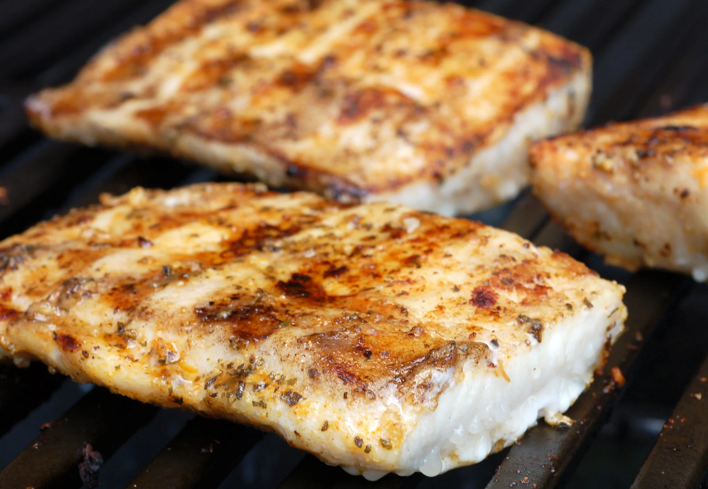 Grilled fish fillets with spices on a barbecue