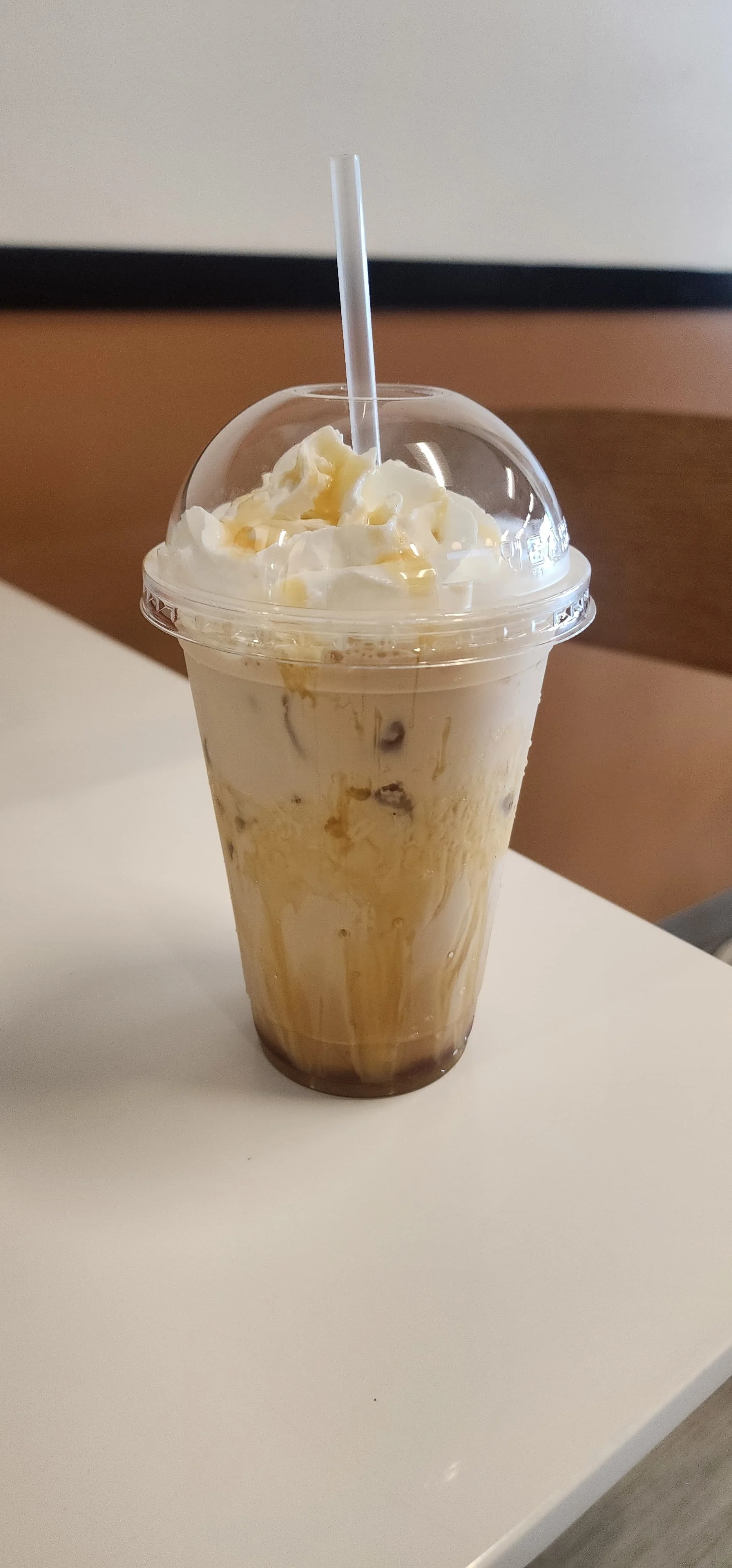 Iced caramel macchiato topped with whipped cream