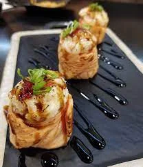 Japanese sushi rolls with eel sauce and scallions