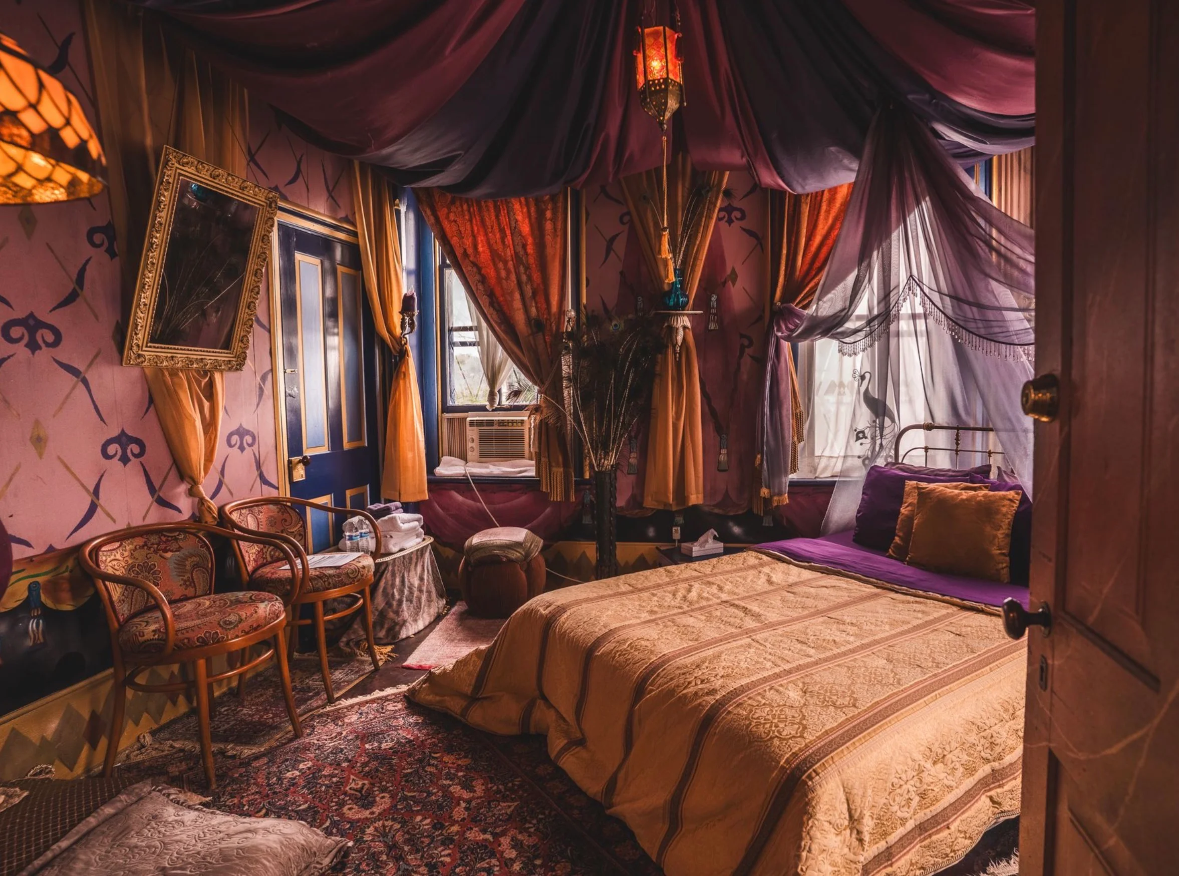 Cozy, colorful bedroom with ornate decor and a warm ambiance.