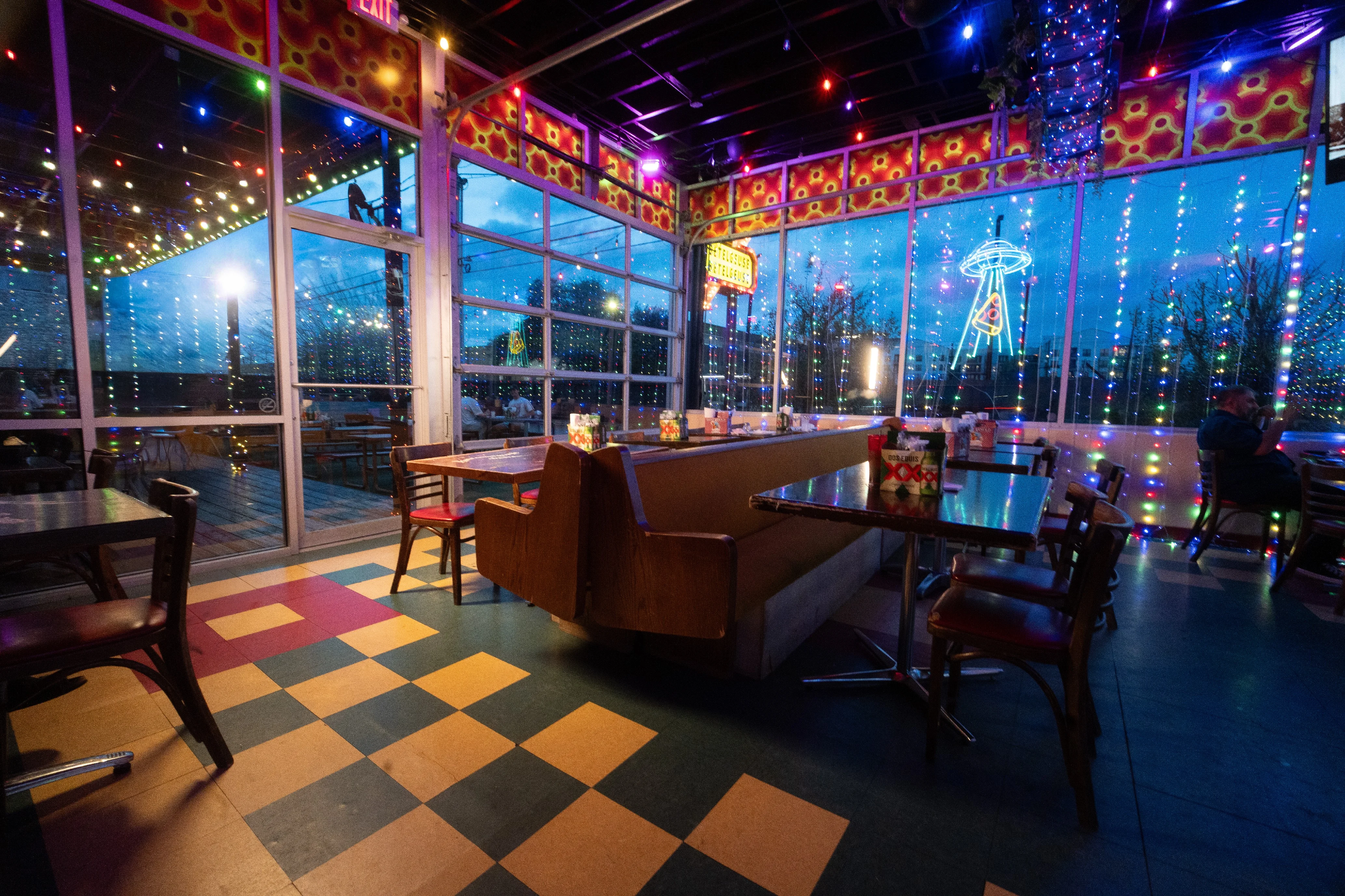 Vibrant restaurant interior with colorful lights and unique decor