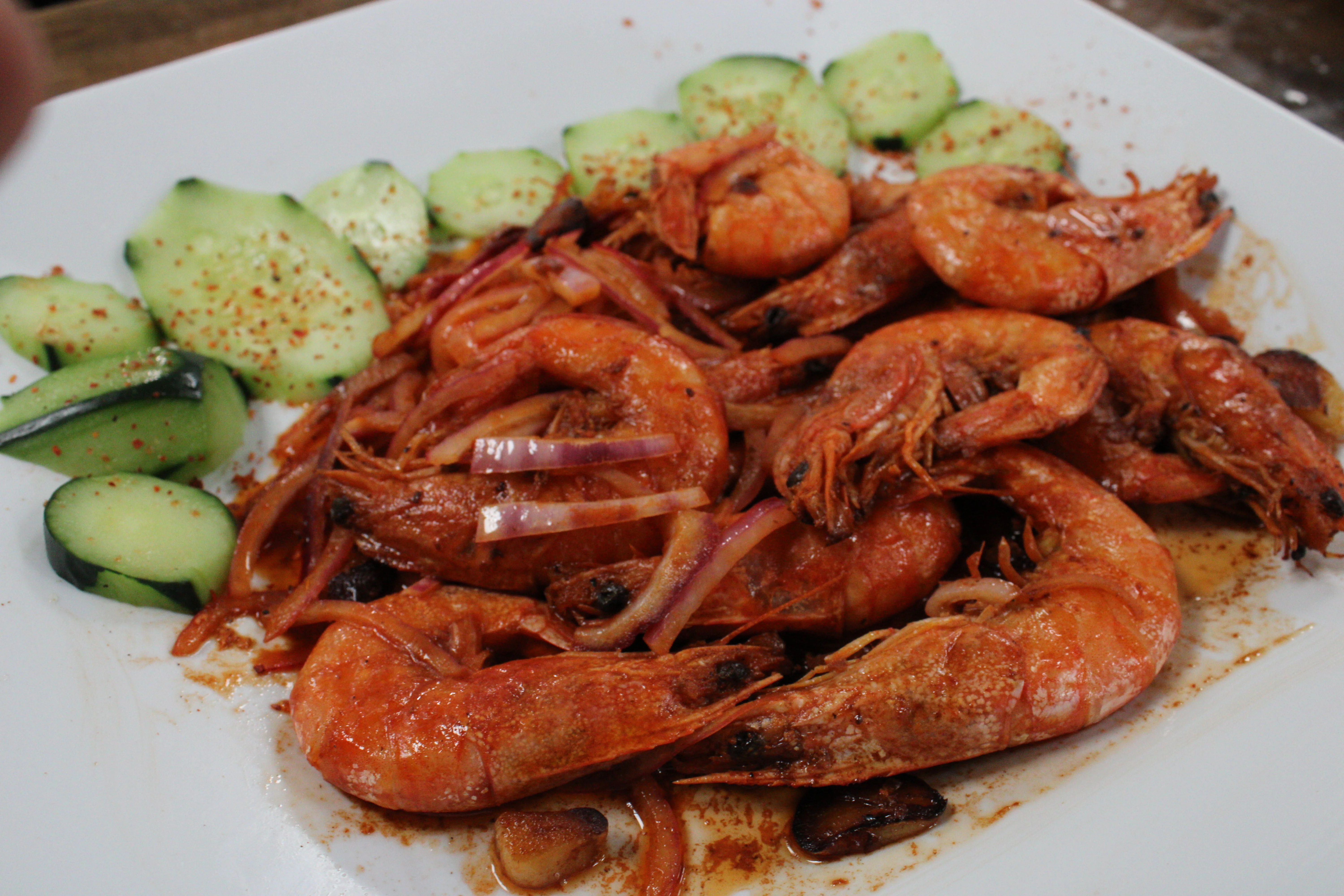 Spicy shrimp dish with cucumbers and onions