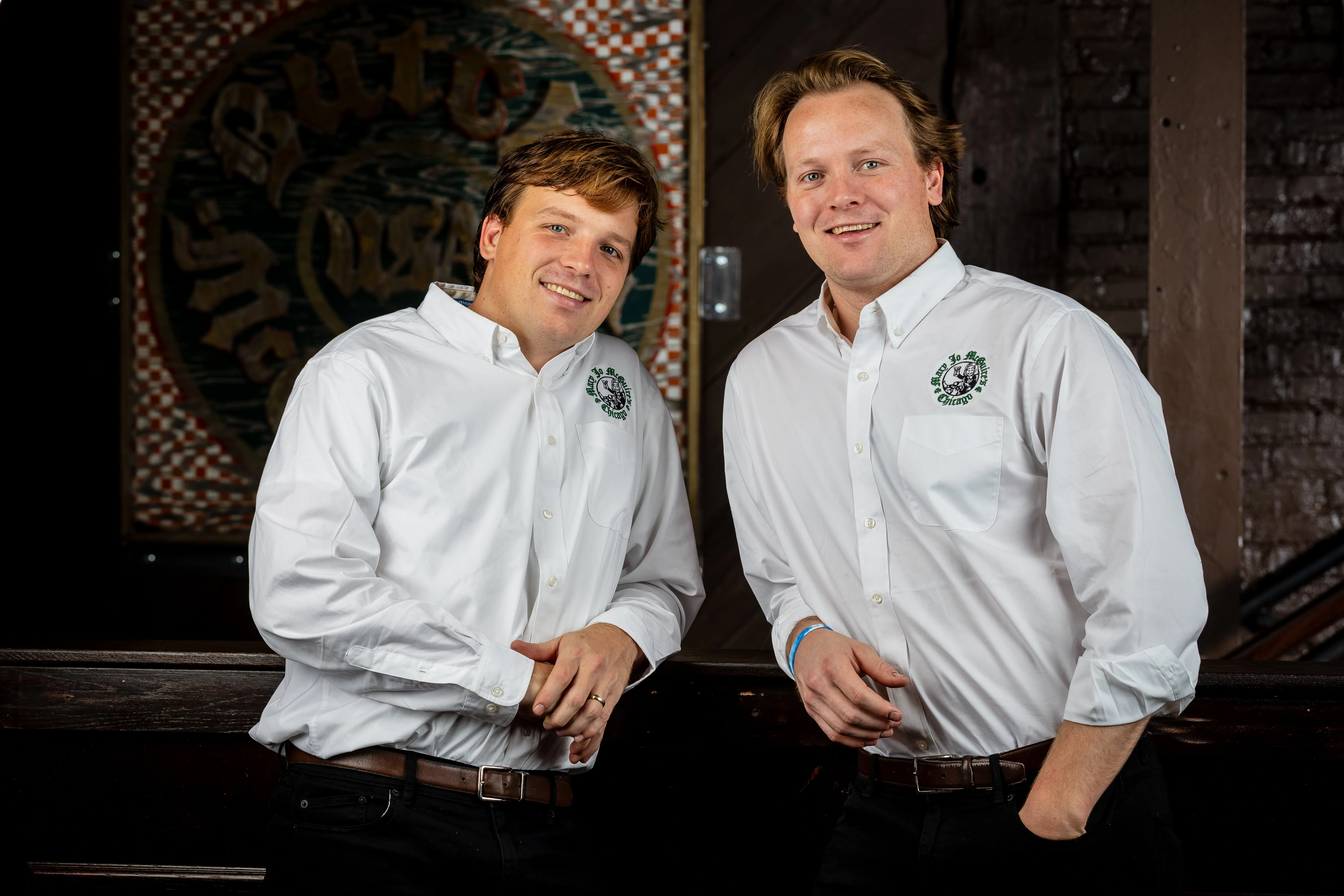Two restaurant staff members posing in a cozy dining area