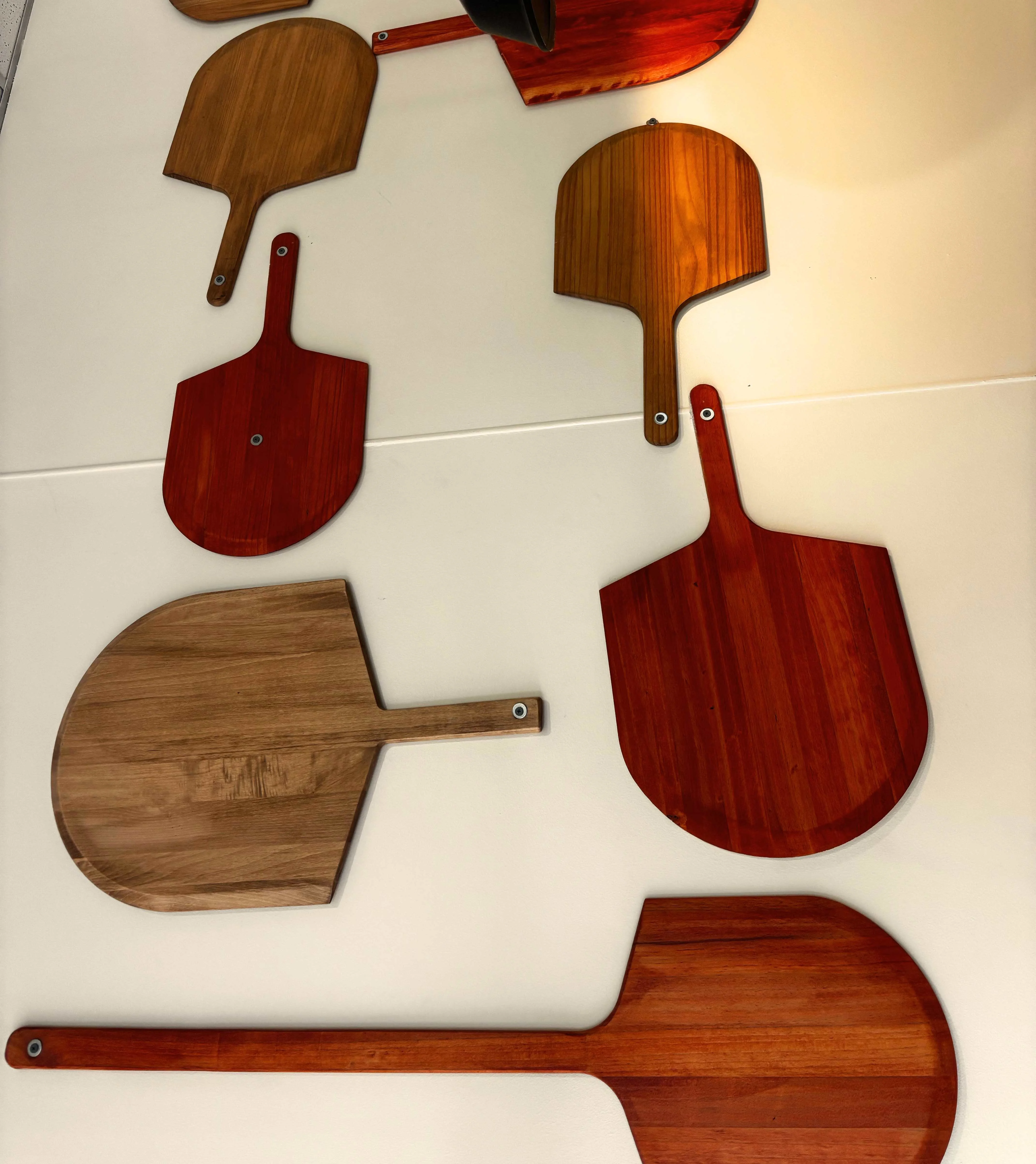 Decorative wooden pizza peels on restaurant wall