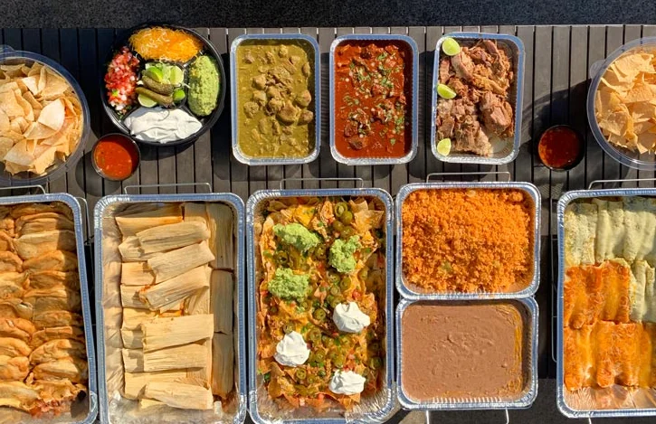 Assorted Mexican feast with enchiladas, tamales, and nachos