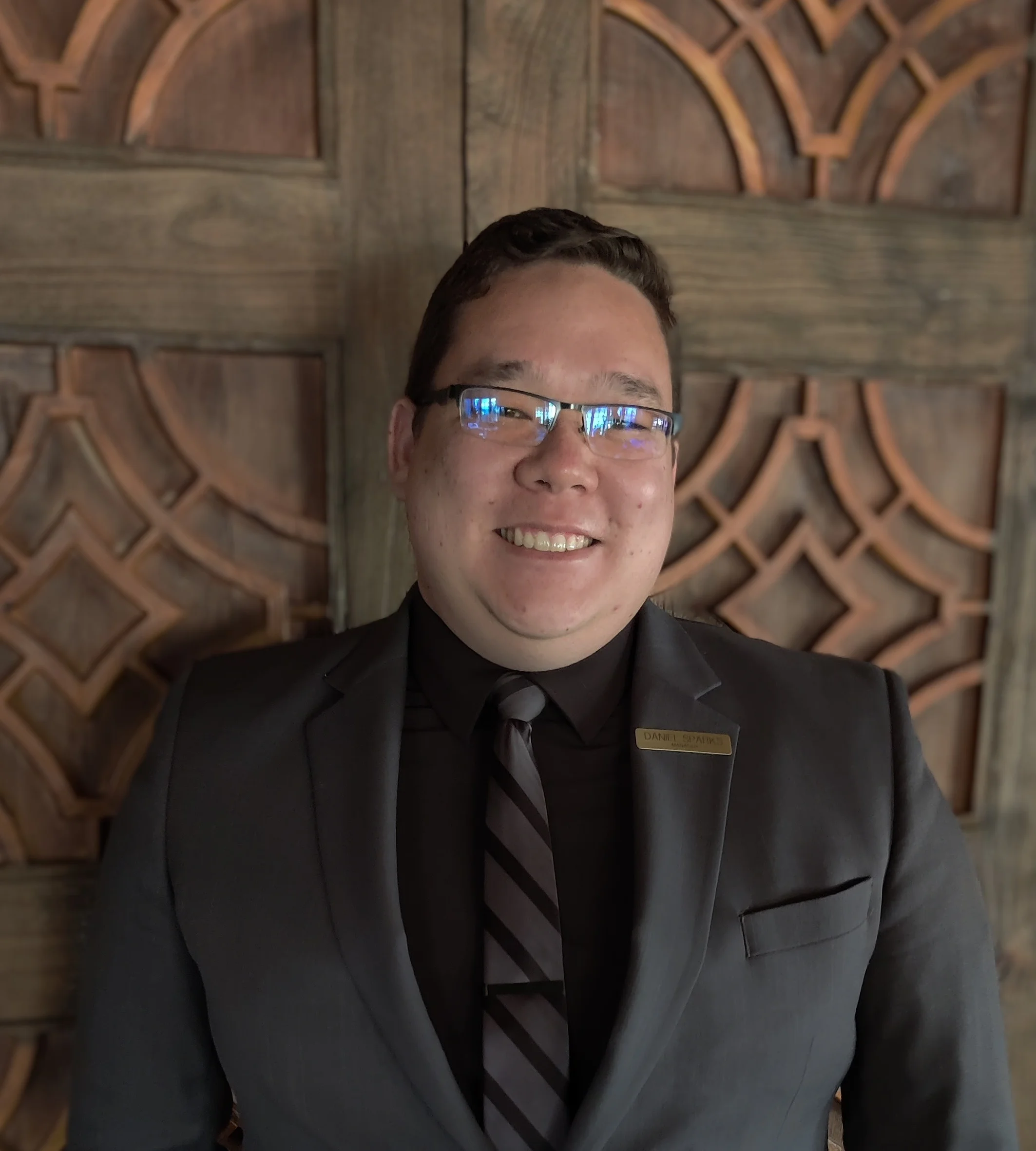 Smiling restaurant staff member in a suit