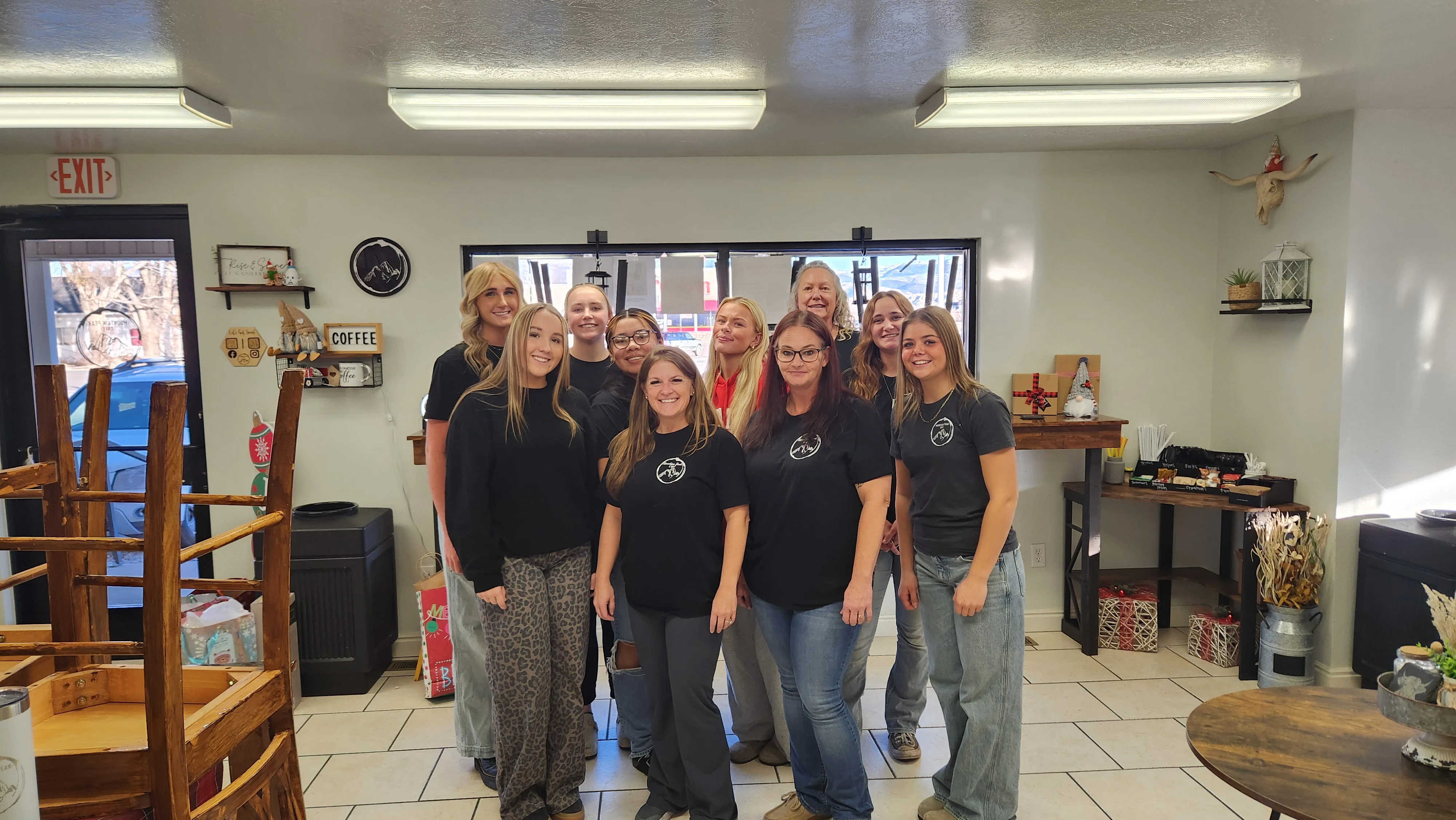 Friendly restaurant staff posing together in a cozy dining area