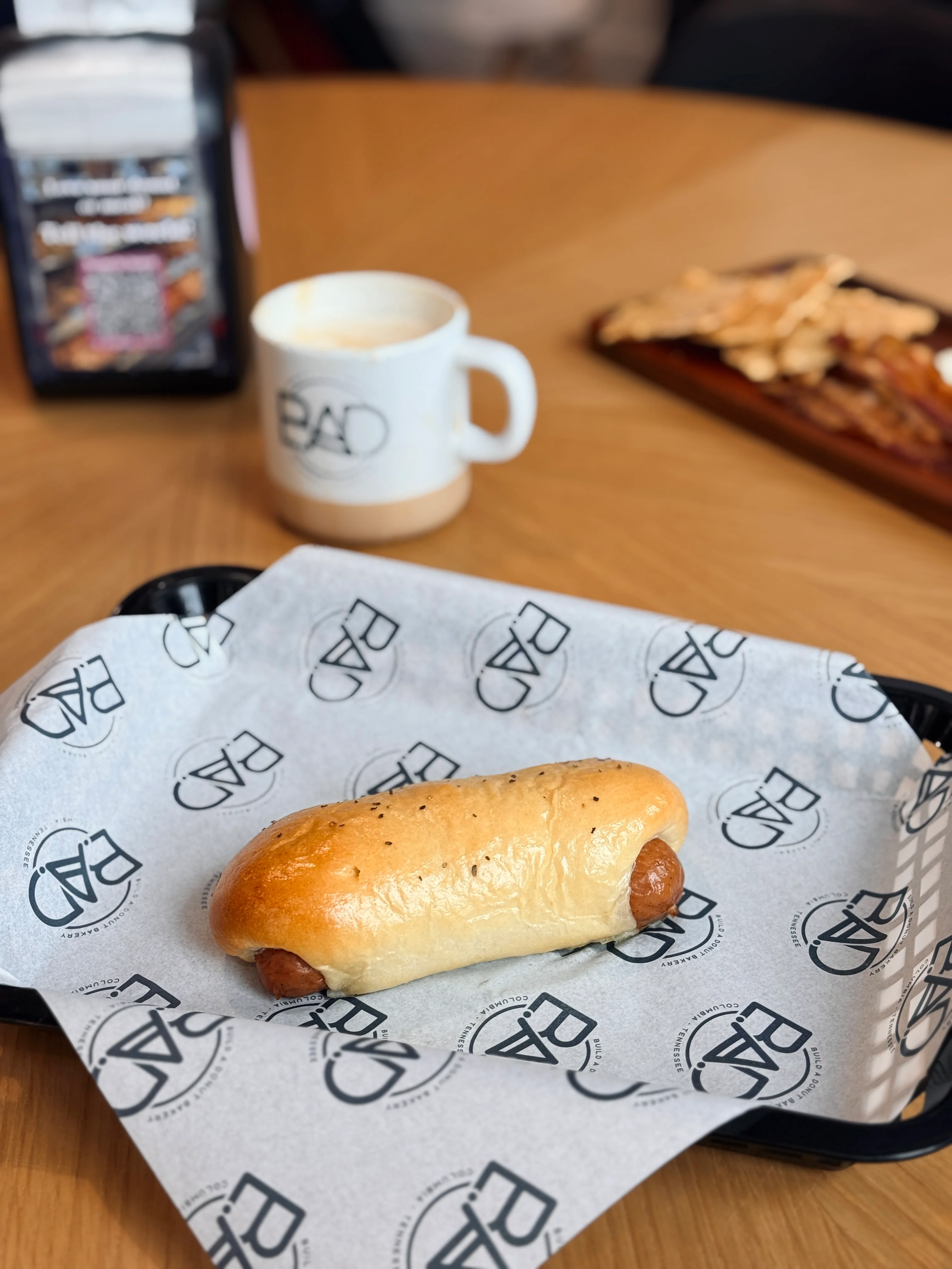 Classic hot dog served in a soft bun on a restaurant tray