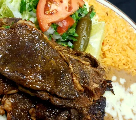 Discover why our Carne Asada is renowned as the best in Radford. This dish features a tender, marinated steak, grilled to perfection with traditional Mexican spices. Served with Mexican rice, refried beans, crisp lettuce, and freshly made pico de gallo. A slice of ripe tomato, a spicy jalapeño, and a wedge of lime. Come taste the vibrant, bold flavors that make us a local favorite!