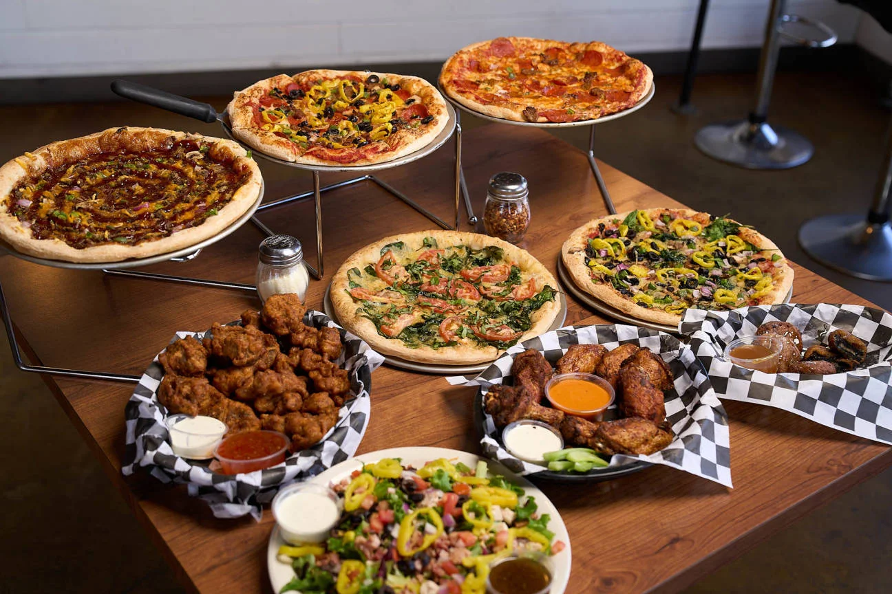 Variety of pizzas and wings in a casual dining setting