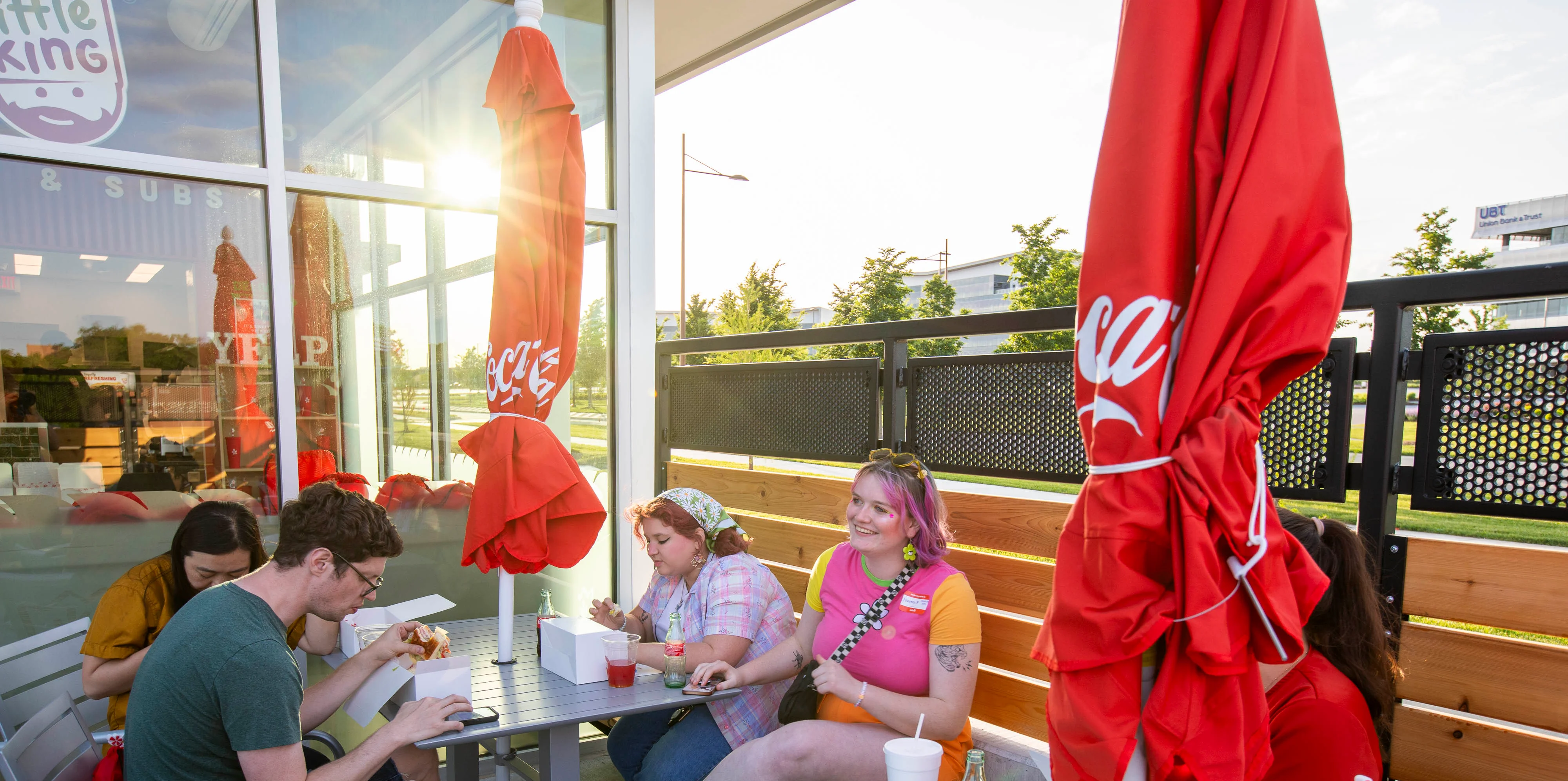 Outdoor dining area with friends enjoying food and drinks