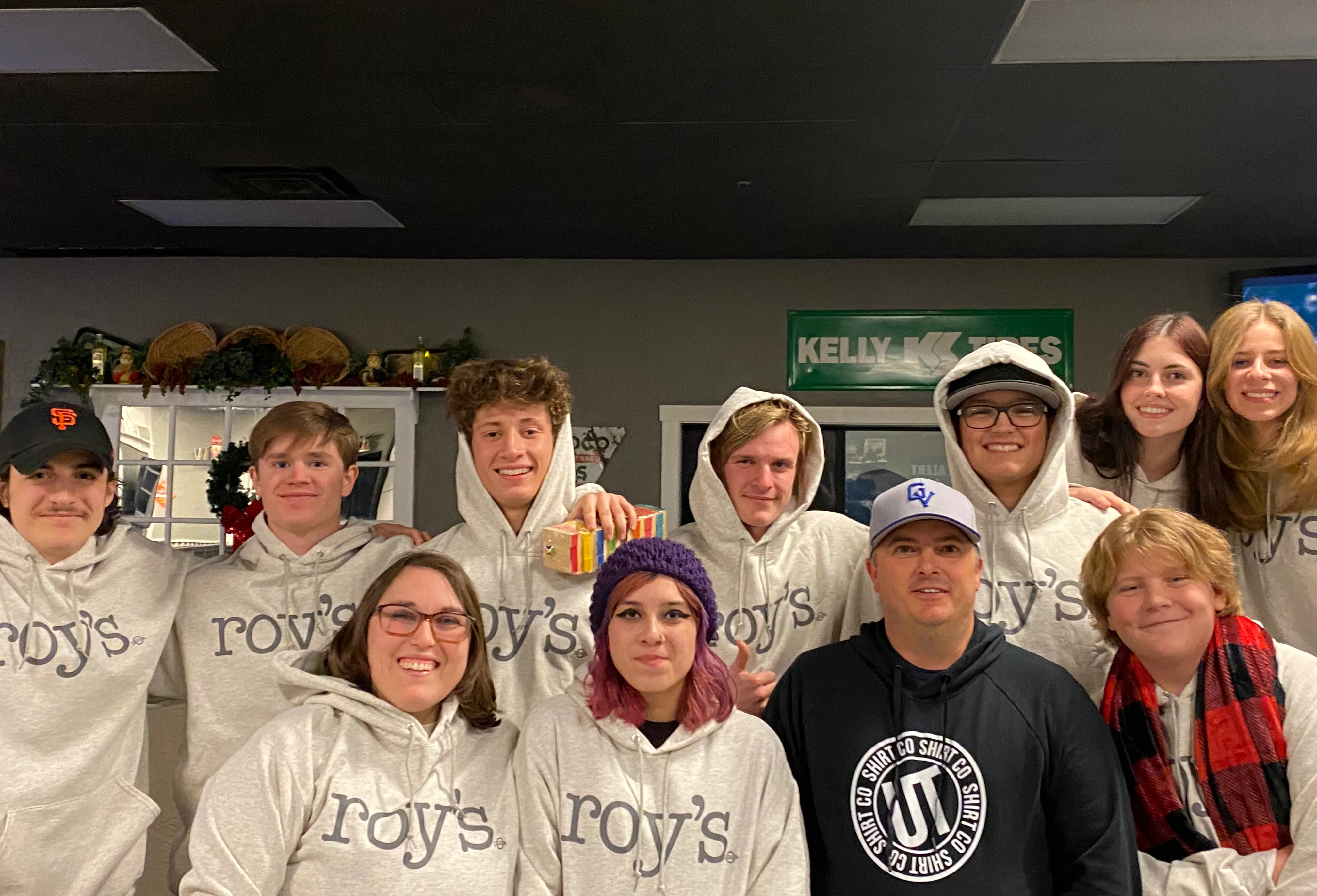 Group of friends in matching hoodies at a cozy restaurant