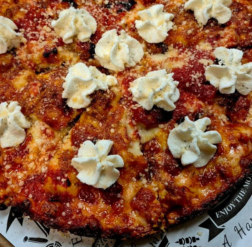 Unique pizza topped with ricotta and marinara sauce