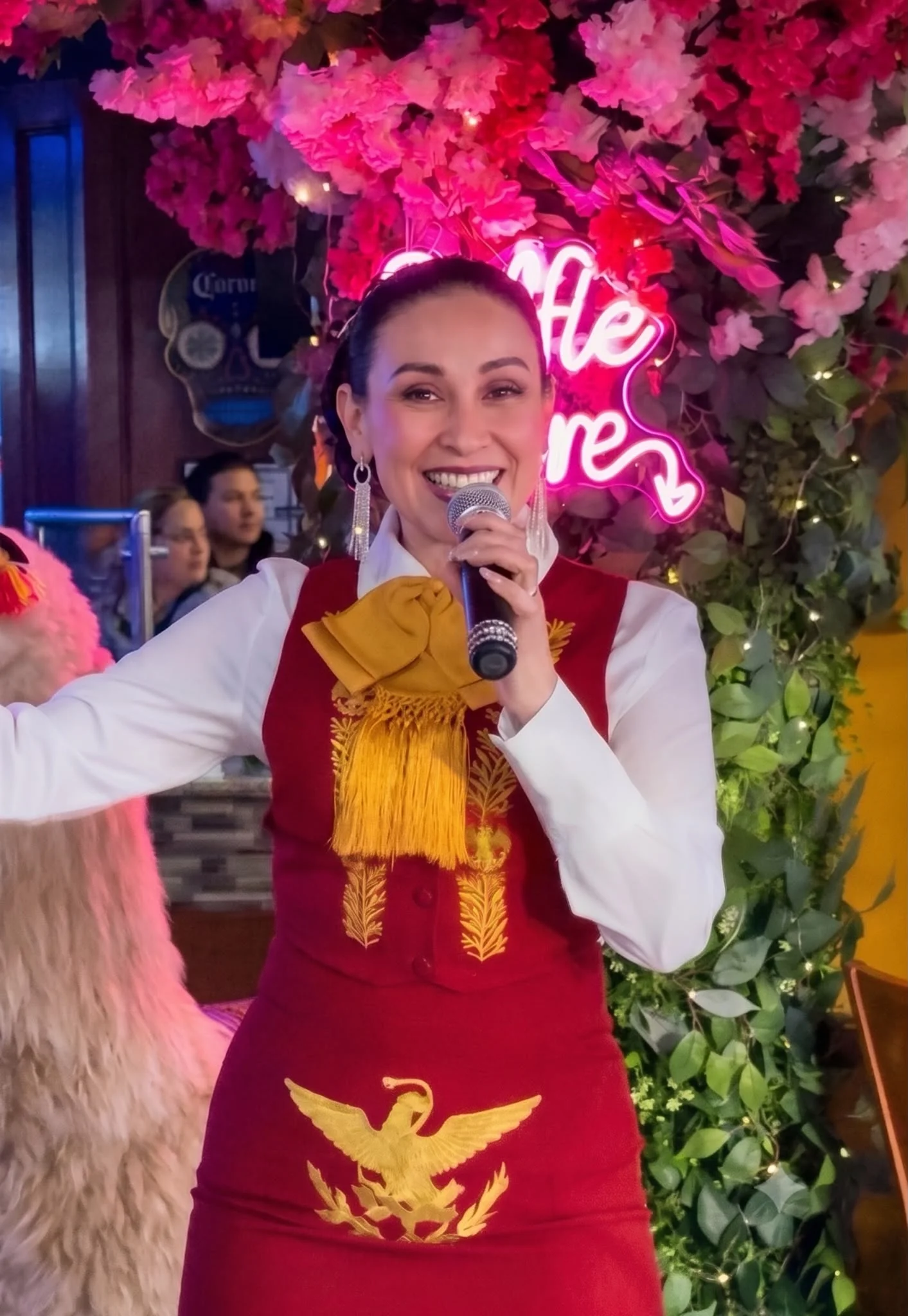 Singer performing at a vibrant restaurant with floral decor