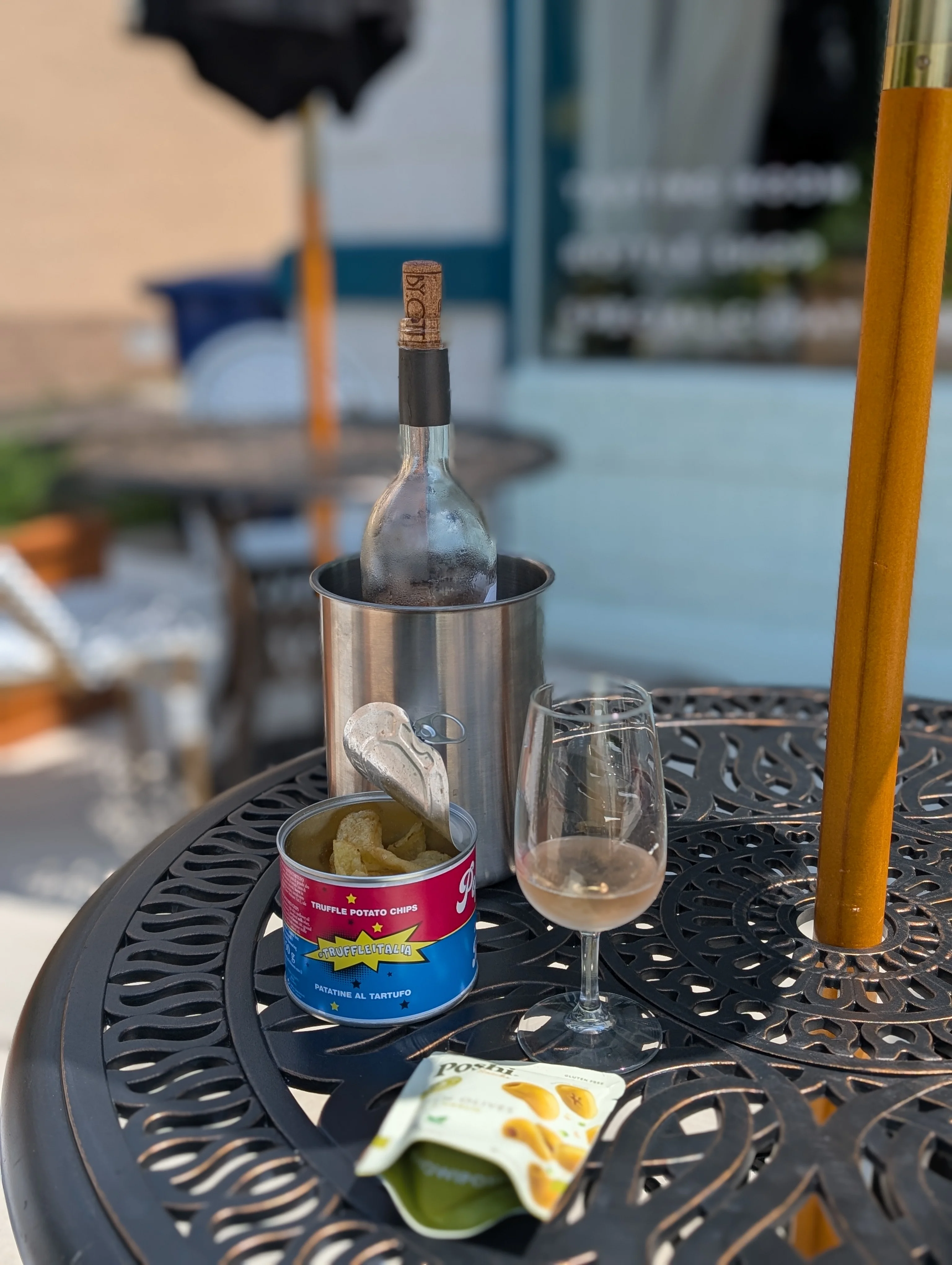 Chilled wine and truffle potato chips on a patio table