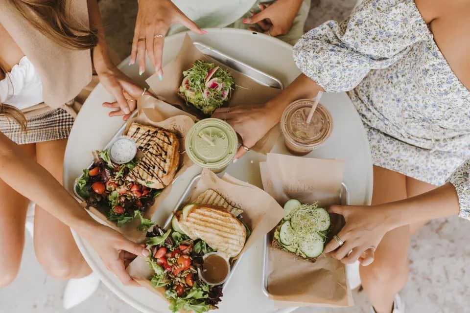 Colorful brunch spread with sandwiches and salads