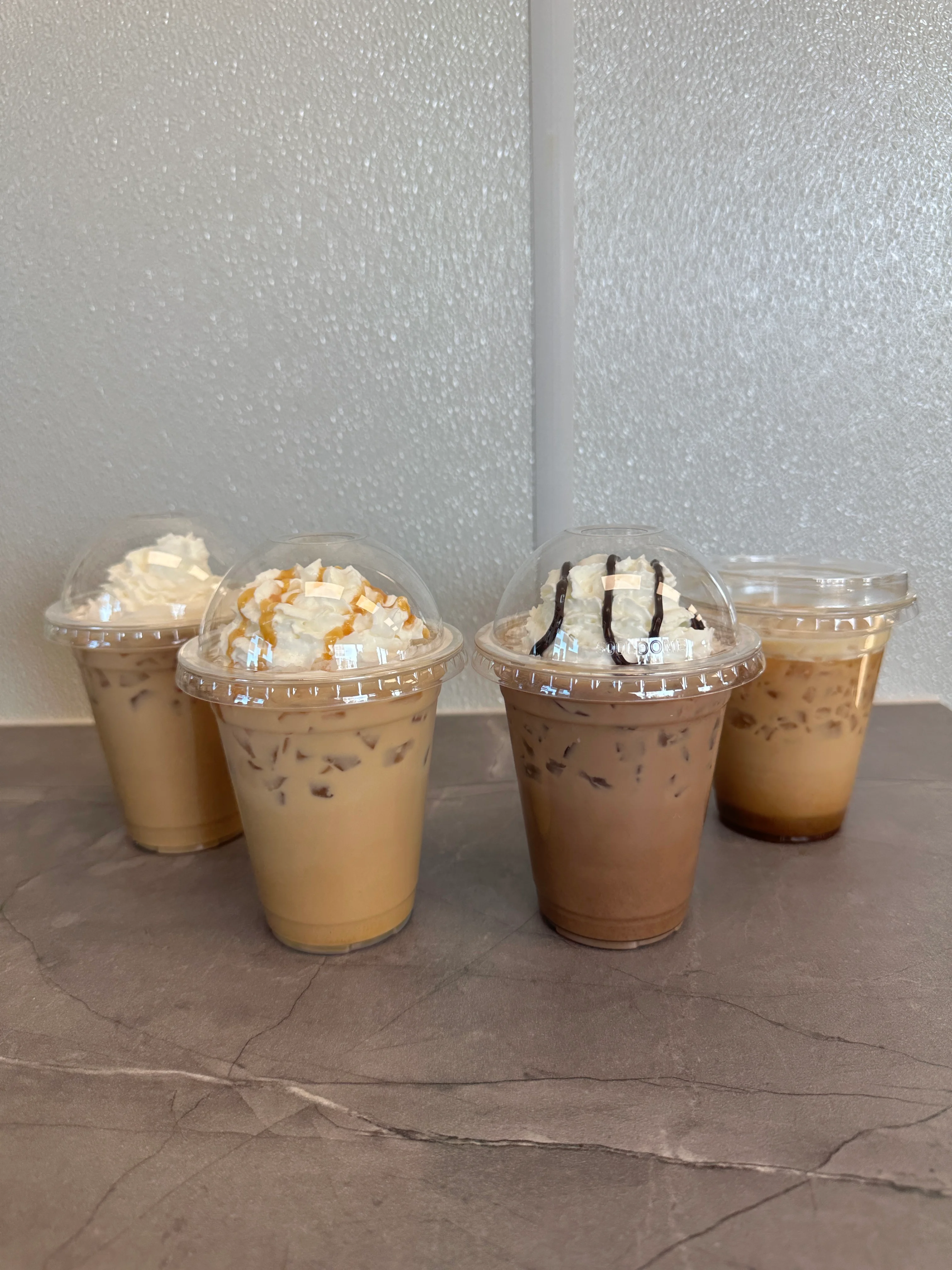 Iced coffee drinks with whipped cream toppings