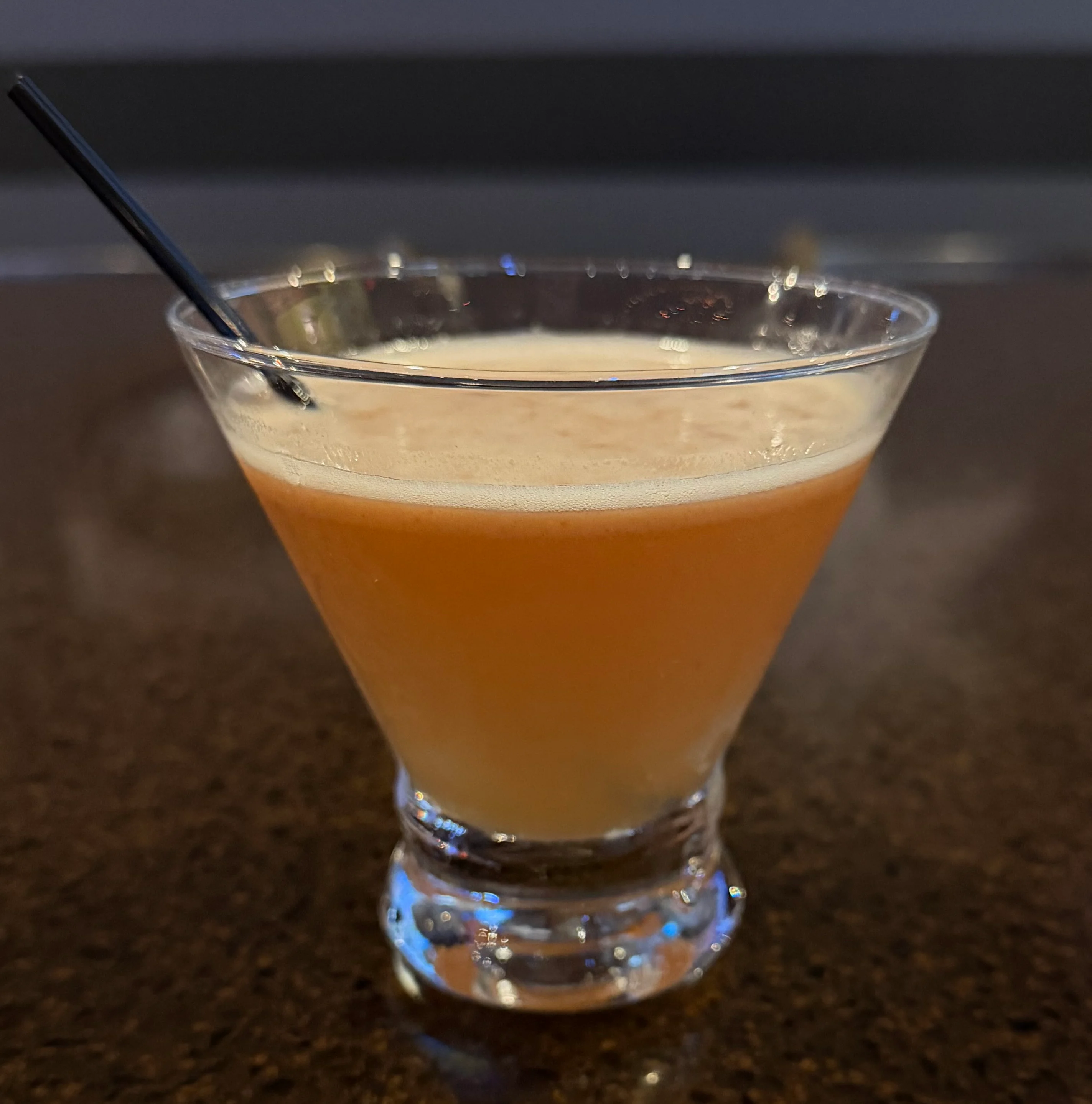 A refreshing Colada cocktail garnished with a slice of pineapple.