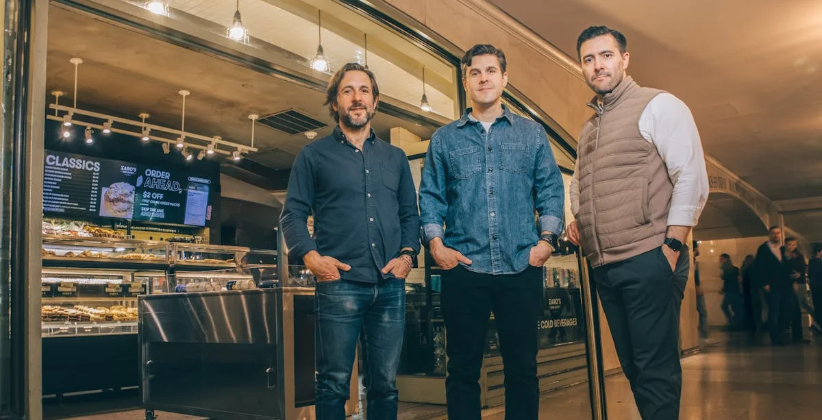 Three restaurateurs outside a modern eatery
