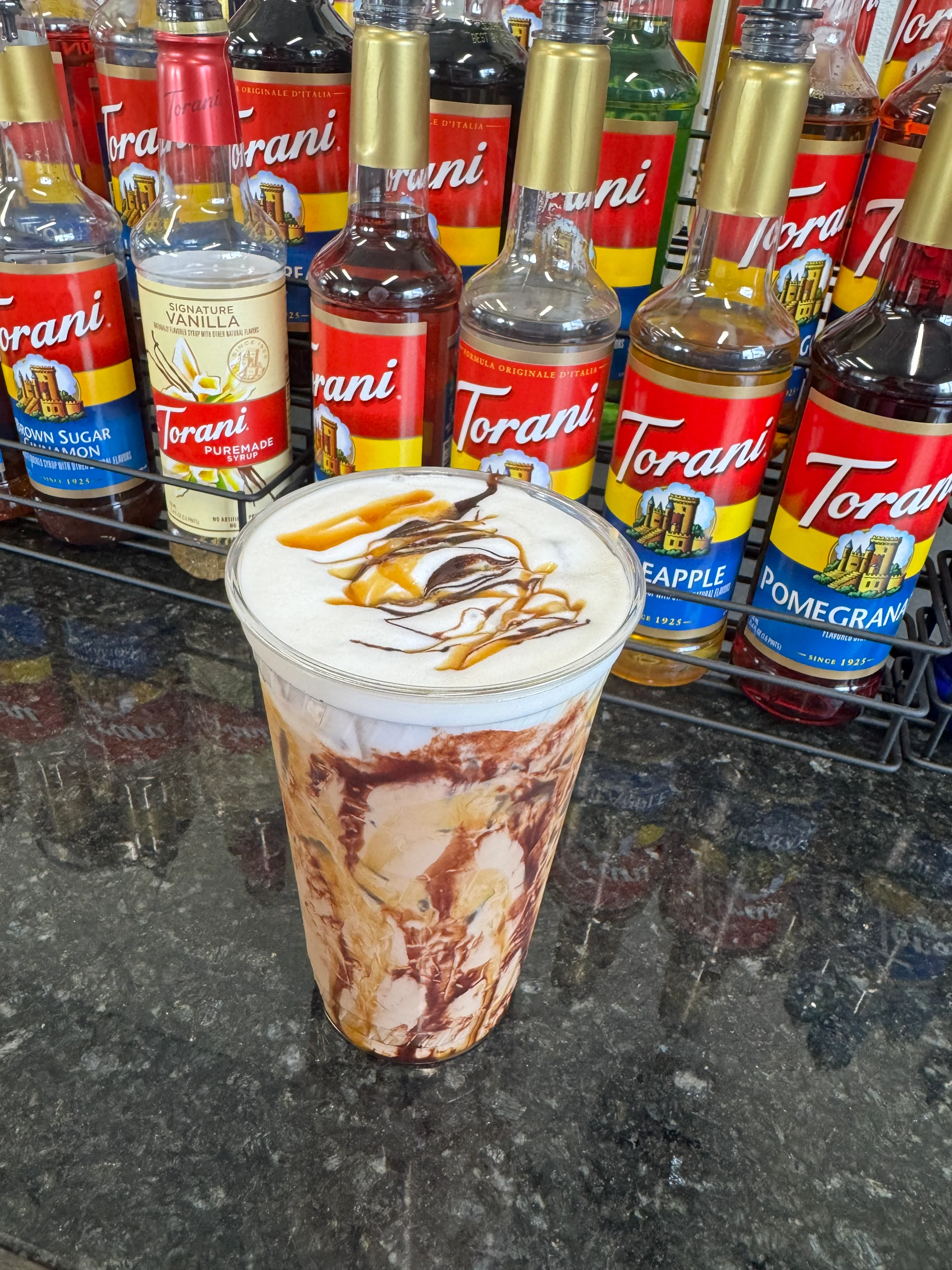 Iced caramel macchiato with swirls of syrup