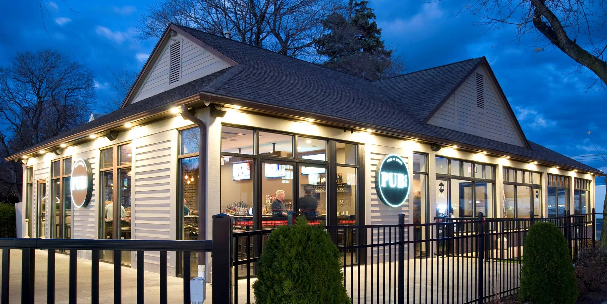 Charming pub exterior with modern lighting and inviting atmosphere