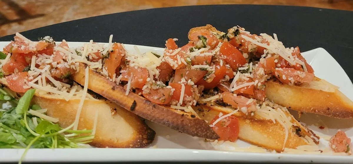 Bruschetta with fresh tomatoes and herbs in a cozy restaurant setting