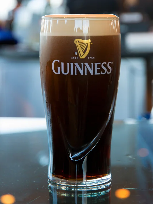 Pint of Guinness stout beer served in a glass