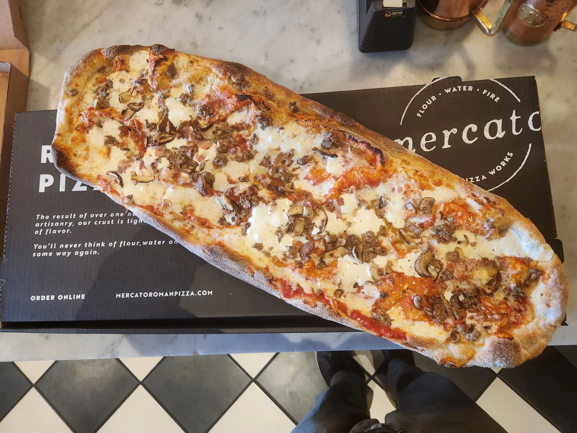 Roman-style pizza topped with cheese and savory toppings