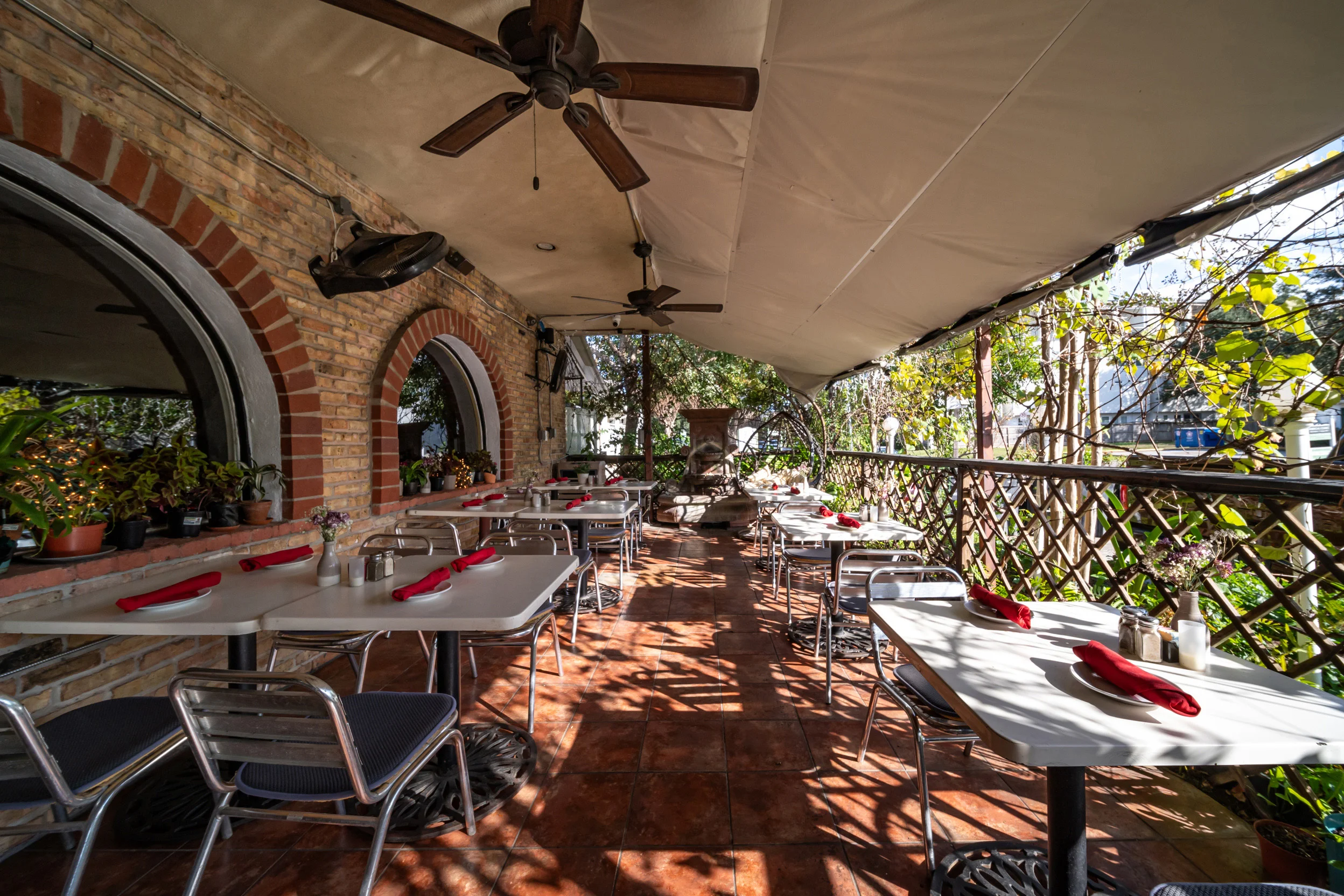 Charming outdoor dining area with tables and greenery