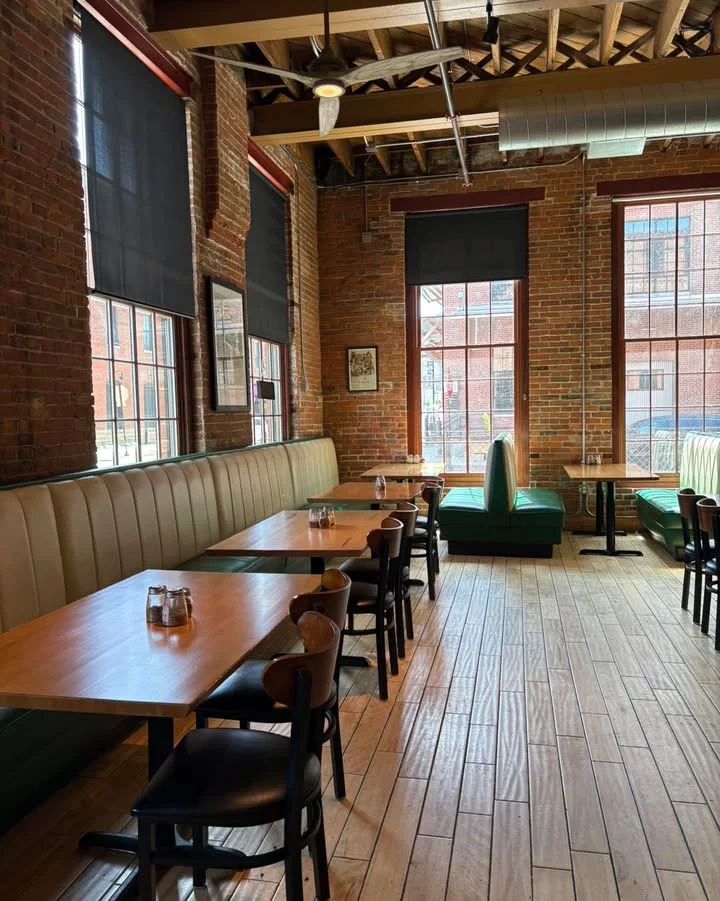 Cozy restaurant interior with exposed brick and wooden floors