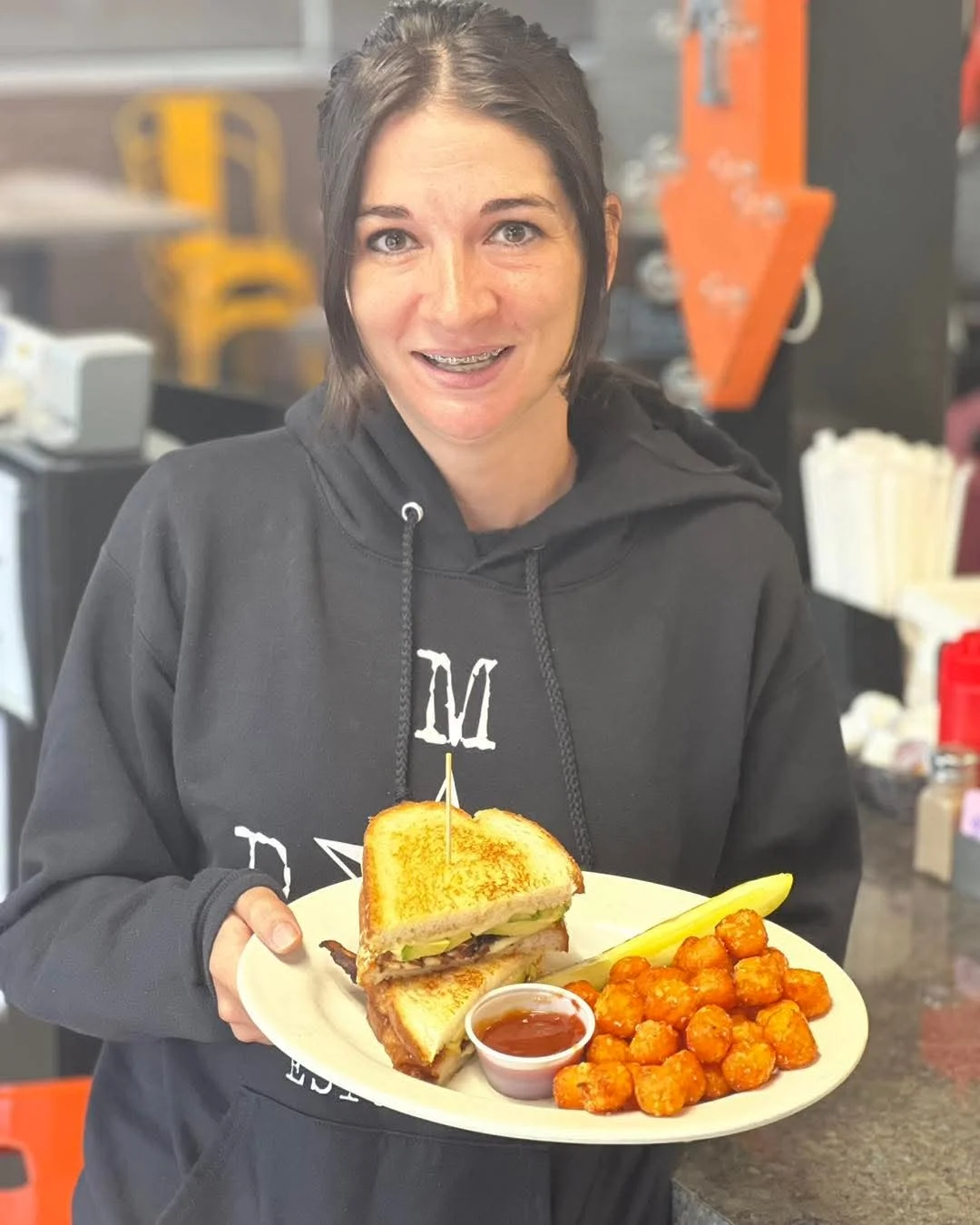 Grilled cheese sandwich with tater tots and dipping sauce