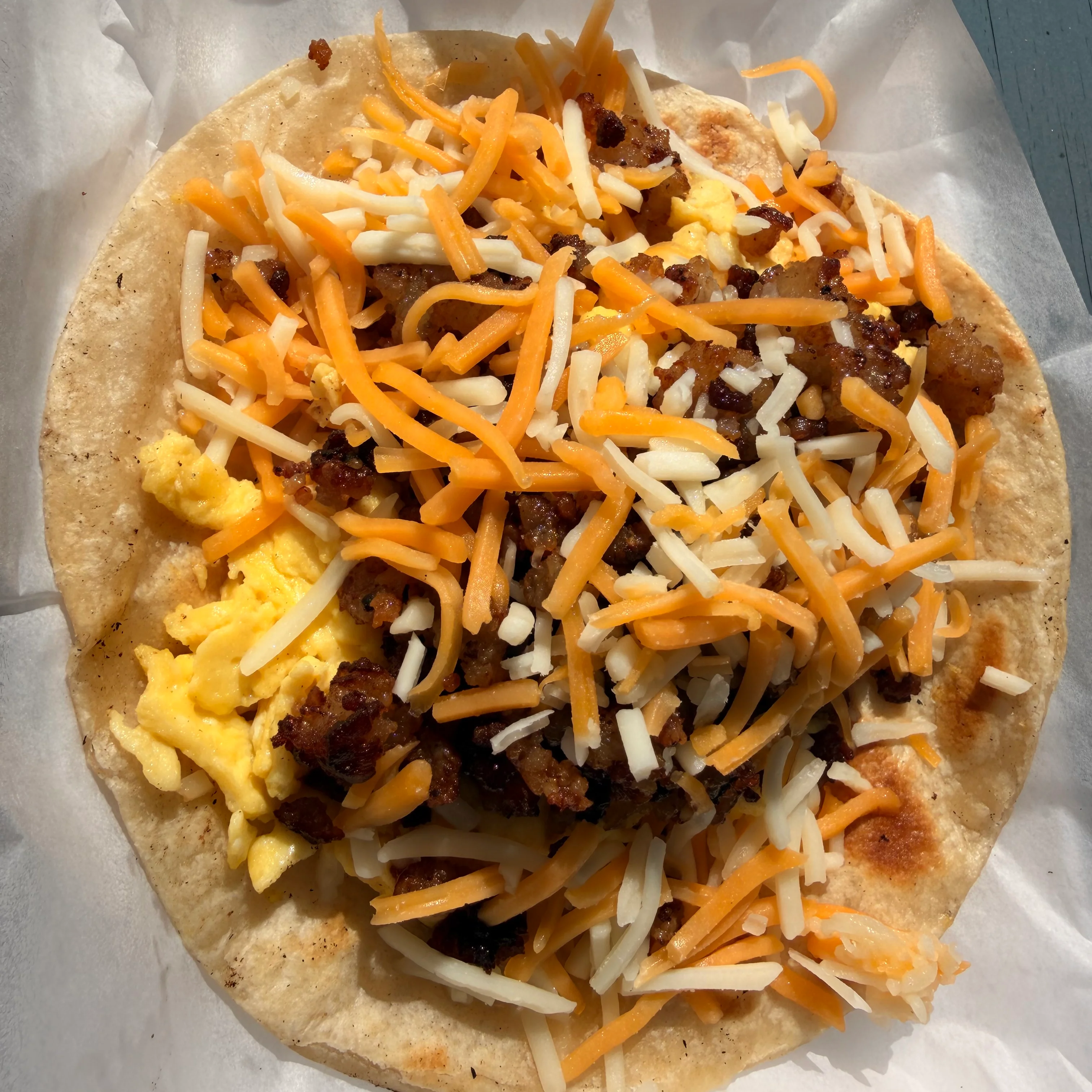 Delicious breakfast taco with scrambled eggs and cheese