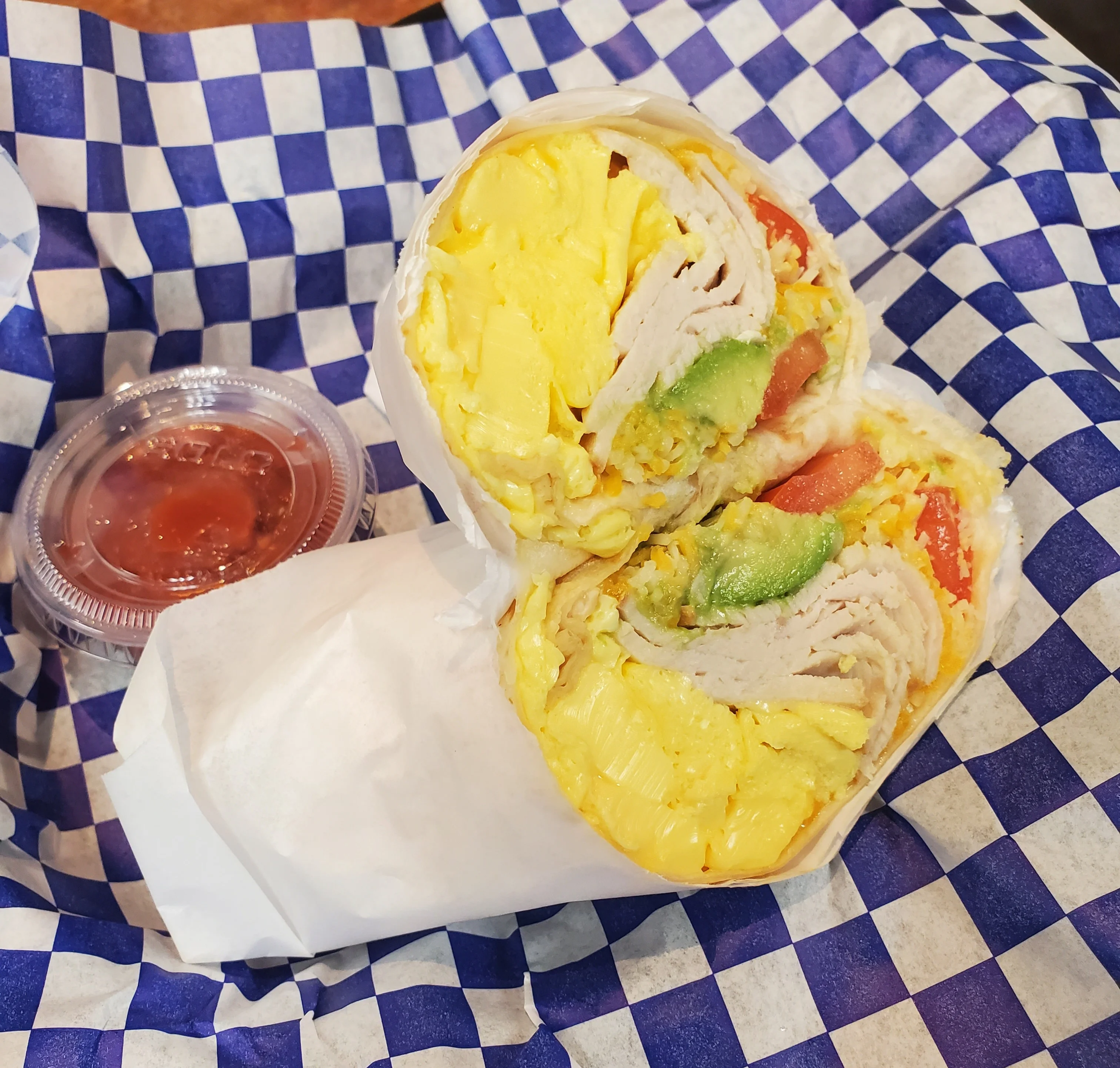 Breakfast burrito with eggs and turkey in a checkered wrapper