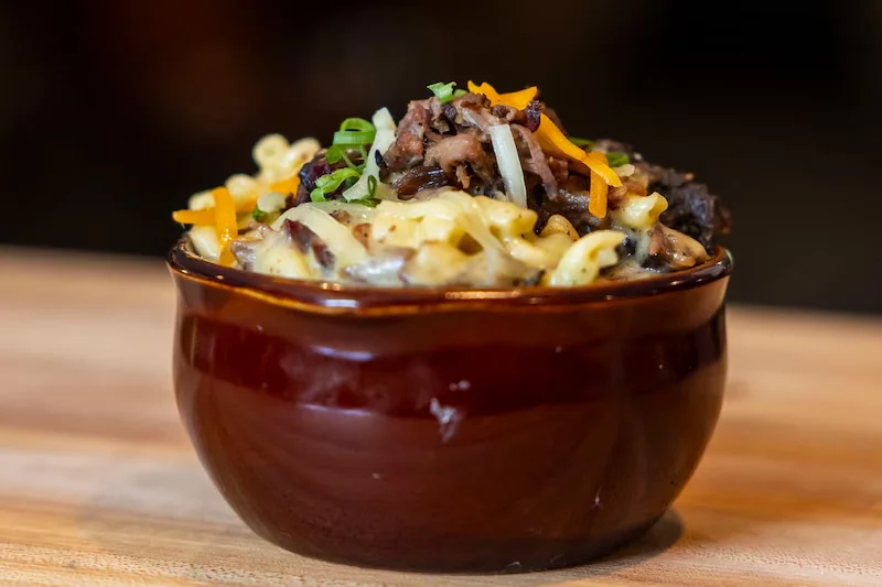 Creamy mac and cheese topped with smoked brisket