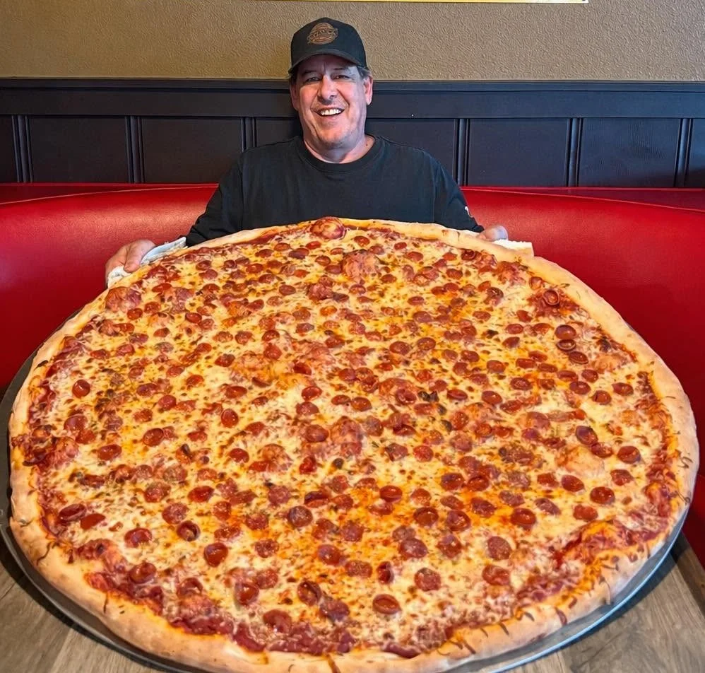 Giant pepperoni pizza served in a restaurant