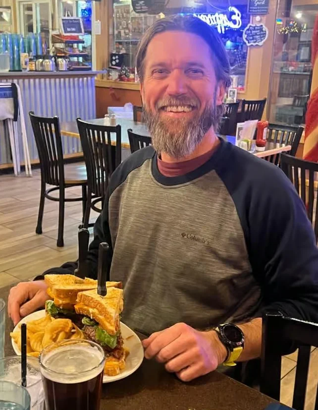 Hearty American club sandwich with fries in a cozy restaurant