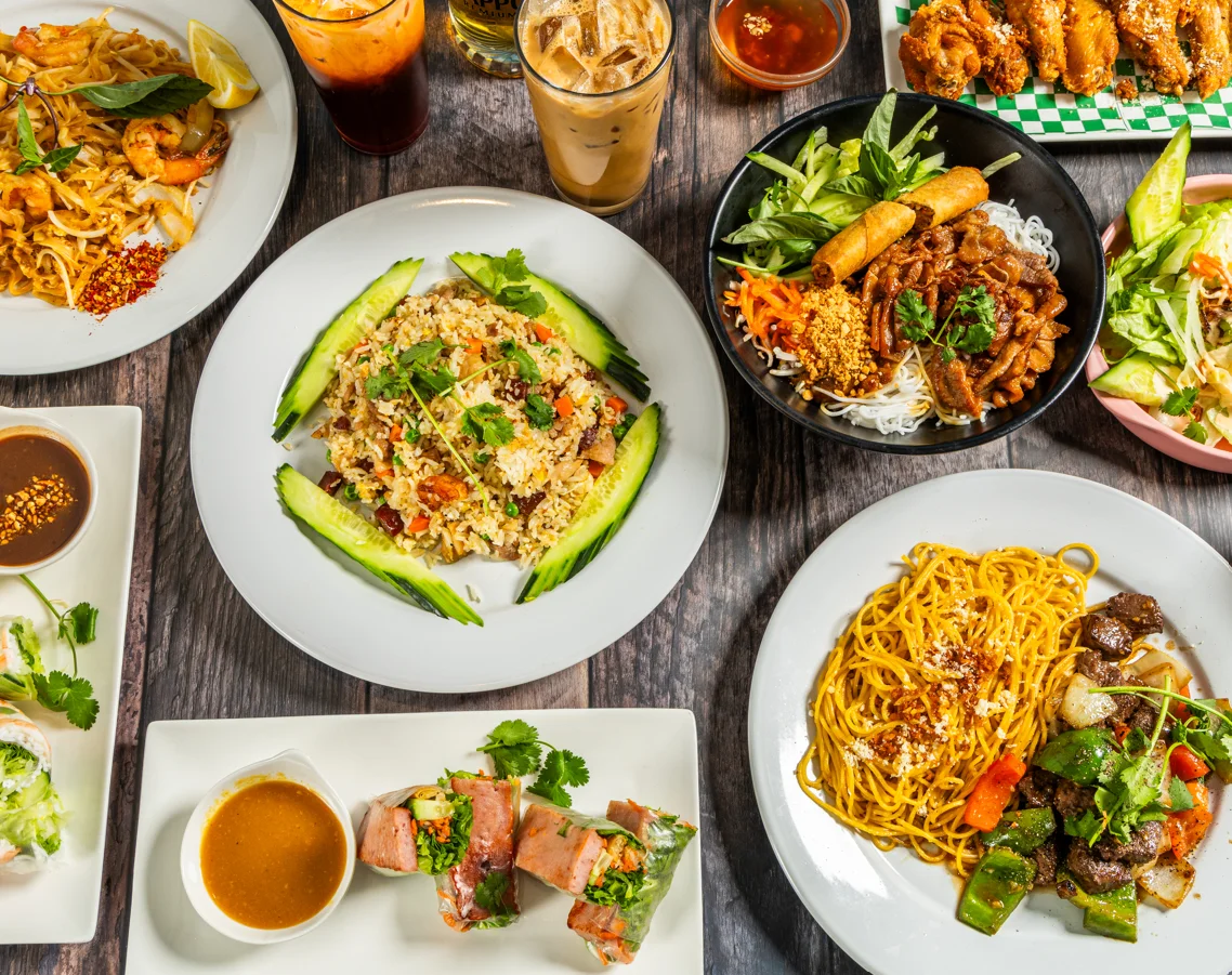 Assorted Asian dishes including pad thai and spring rolls