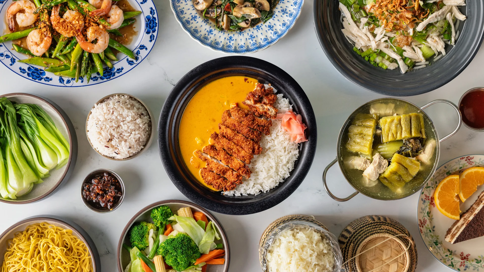 Assorted Asian dishes including chicken katsu curry and stir-fried vegetables