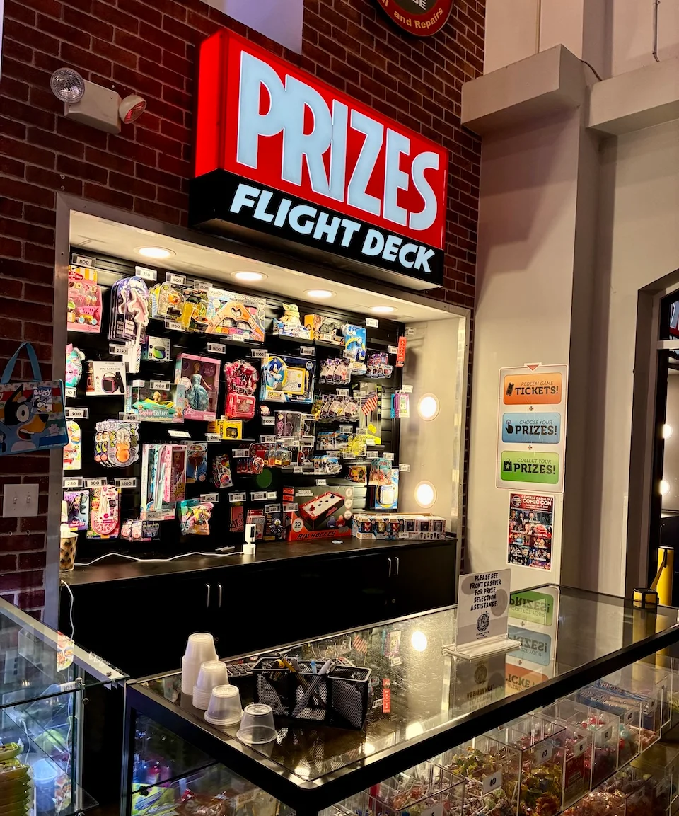 Arcade prize counter displaying colorful toys and collectibles