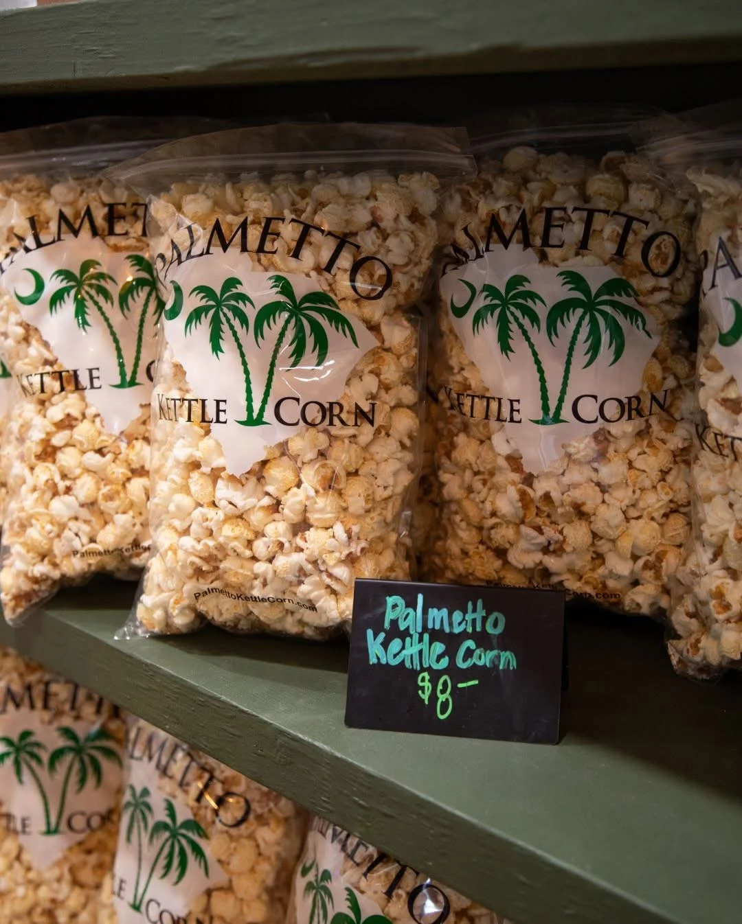 Bags of Palmetto kettle corn on a wooden shelf