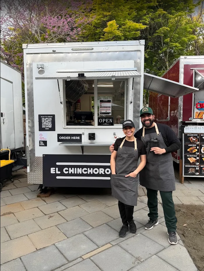 Two food truck owners posing in front of their truck 'El Chinchoro'.
