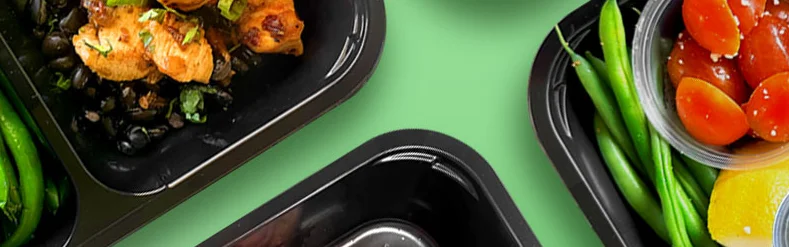 Assorted meal prep containers with grilled chicken and vegetables