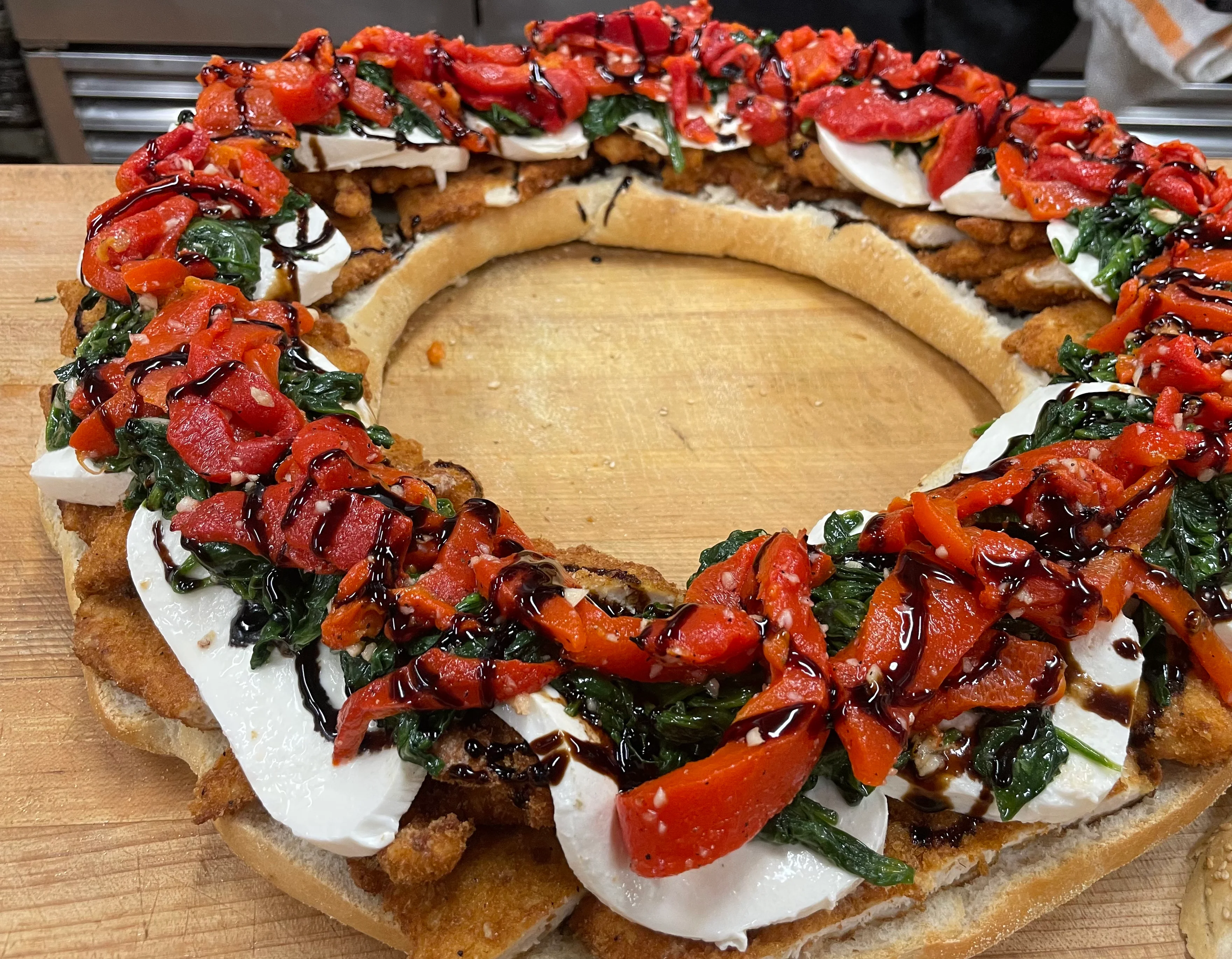 Large sesame-covered round bread filled with colorful vegetables.