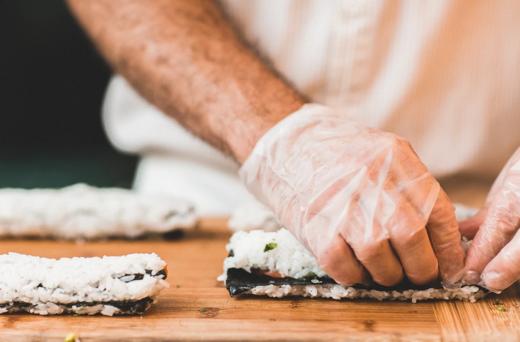 Chef preparing sushi rolls with precision